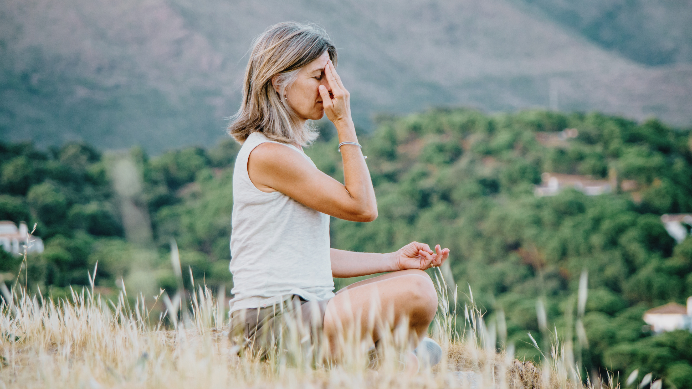 a woman meditating on a yoga retreat