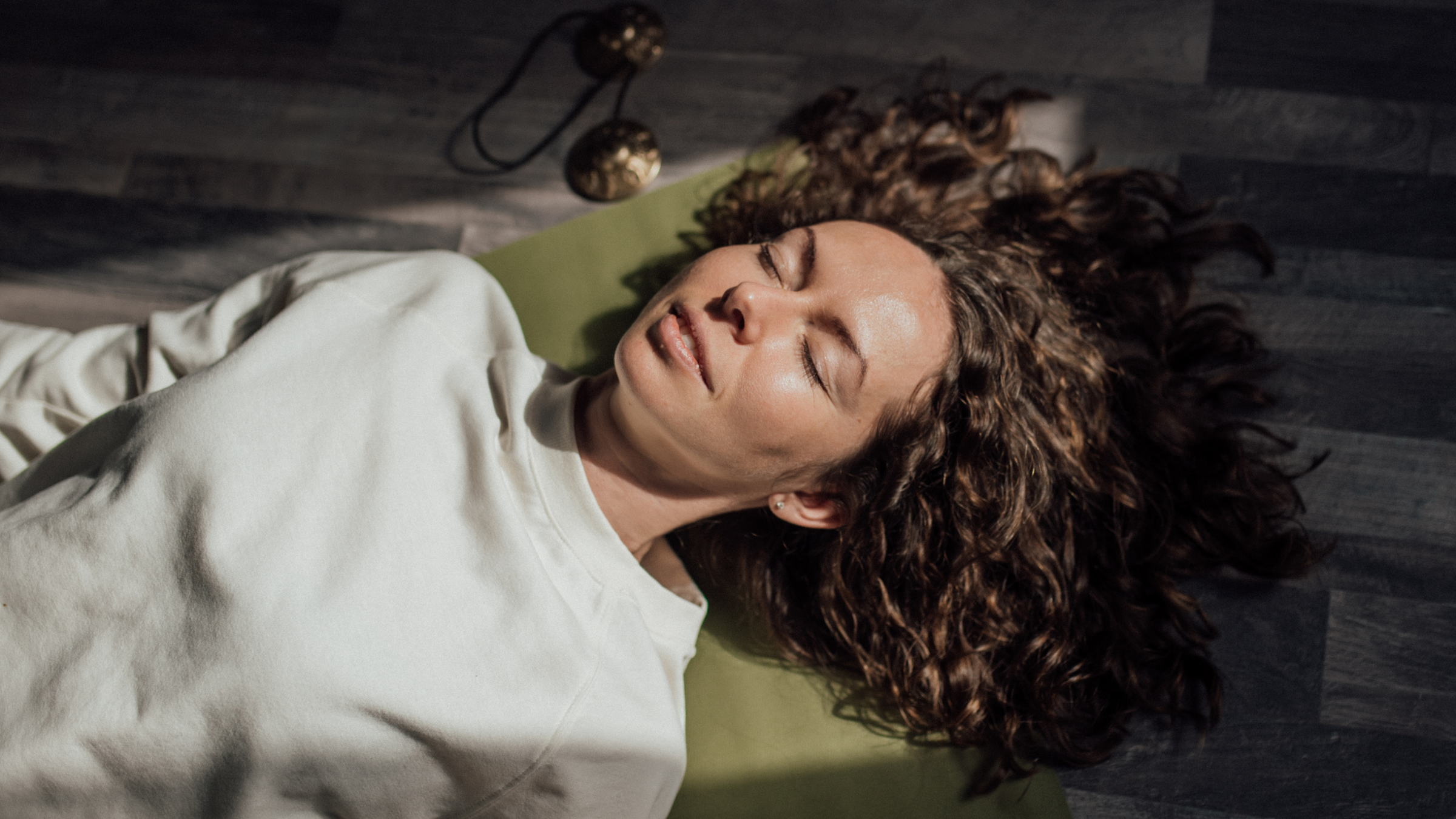 A woman in Savasana at the end of yoga class