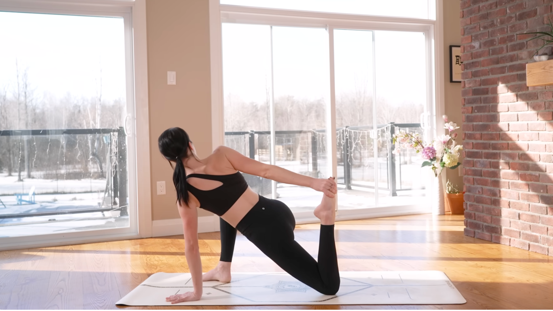 Woman on a yoga mat kneeling in a Low Lunge Twist