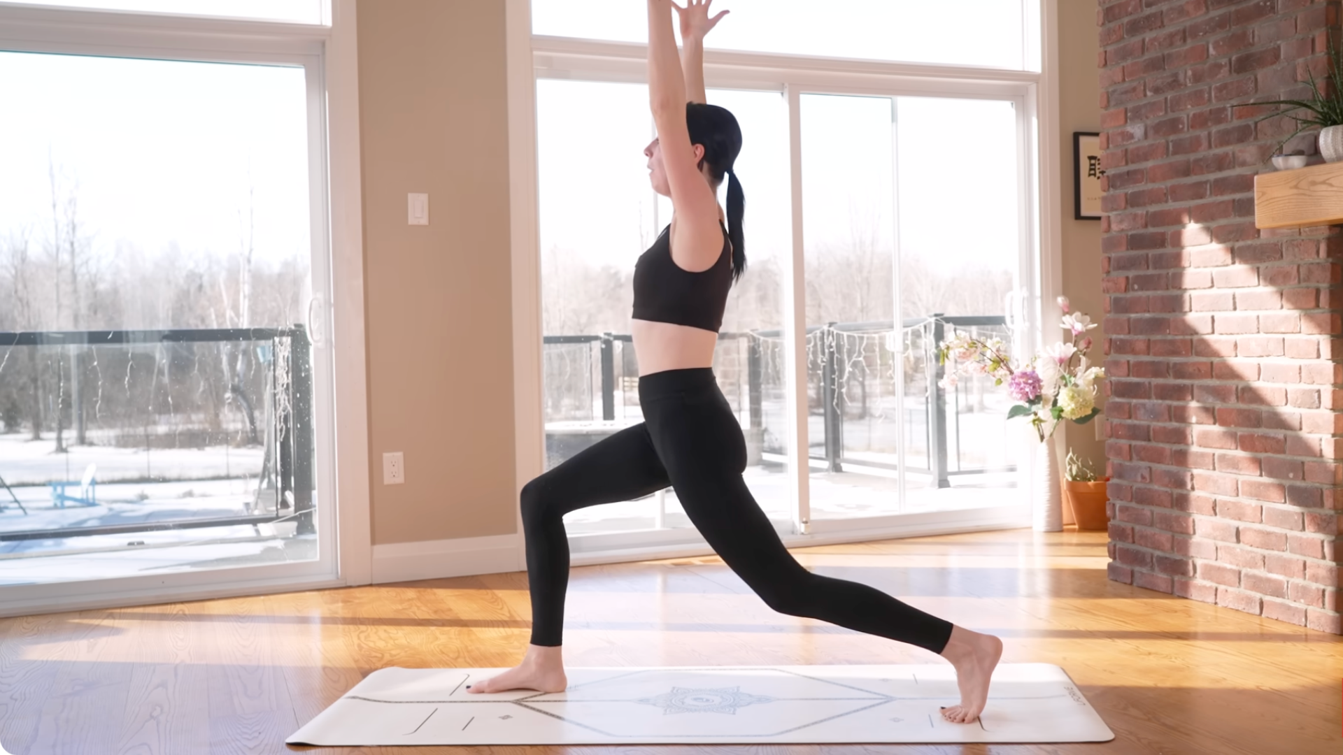 Yoga teacher practicing High Lunge on a yoga mat