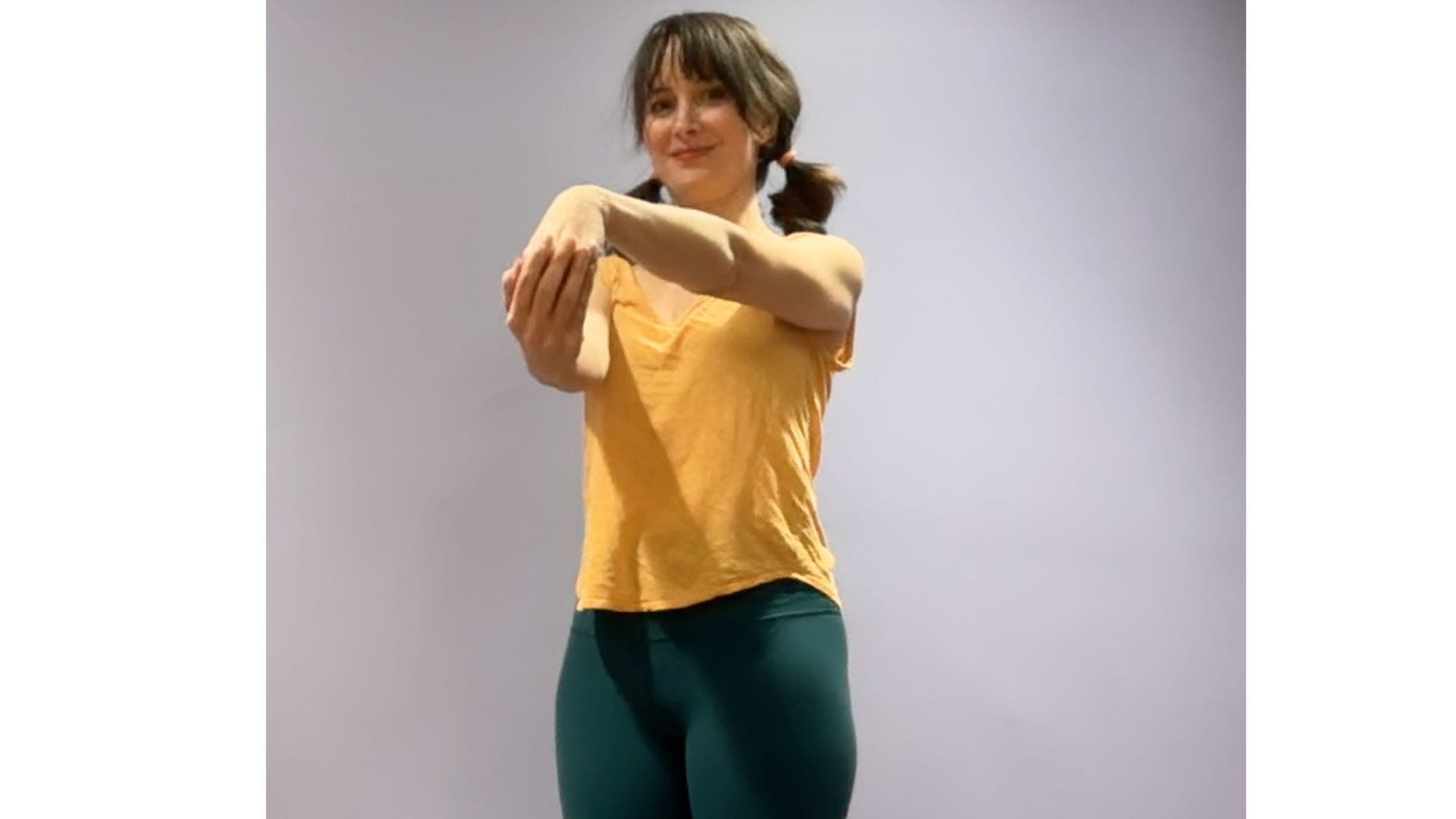 Image of yoga teacher Amber Burke demonstrating wrist flexion stretch.