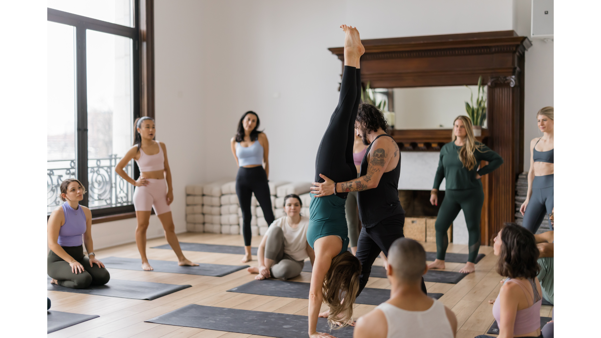 Yoga teacher helping someone learn how to come into Handstand