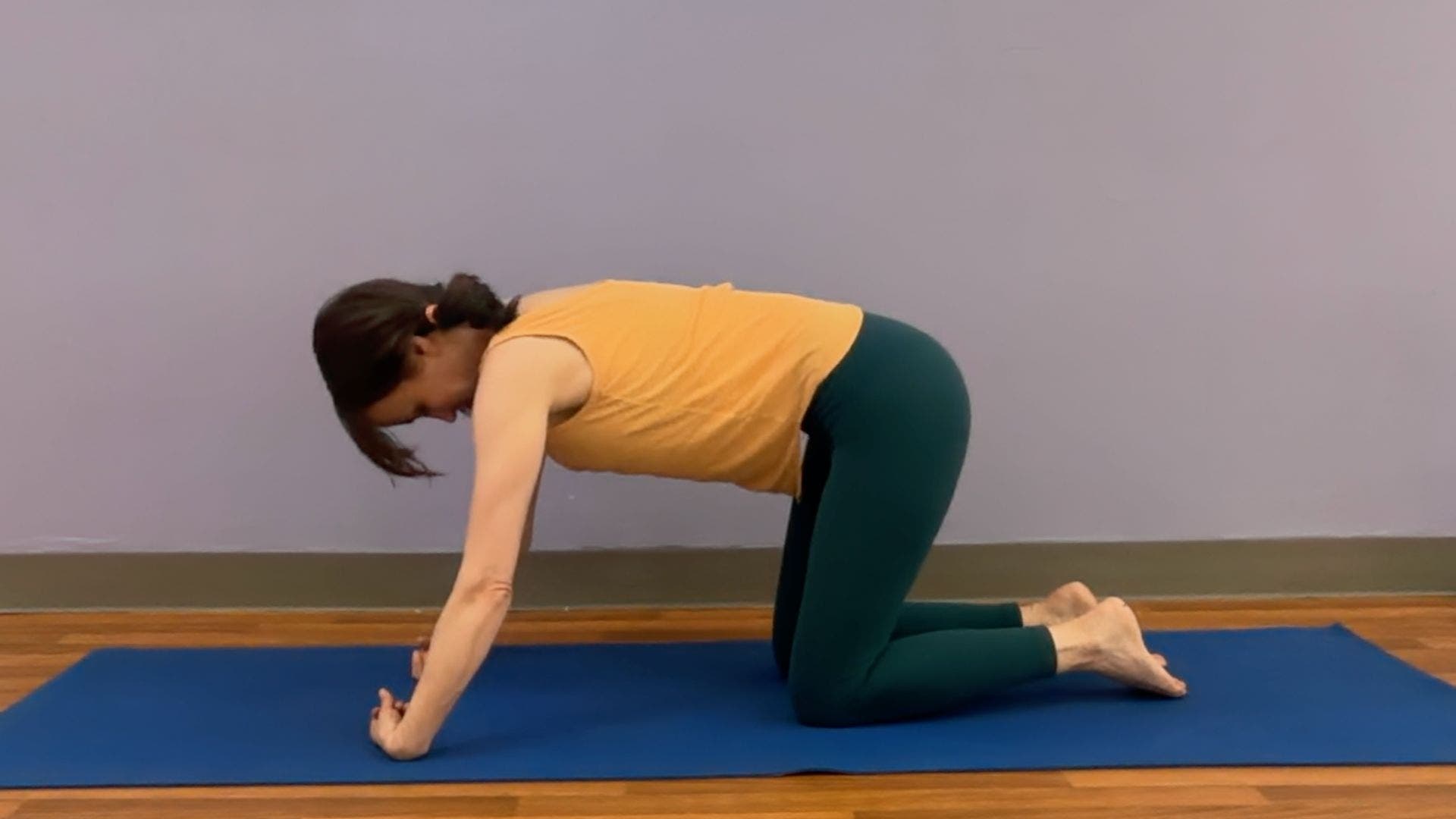 Amber Burke demonstrating wrist flexion stretch from Tabletop.