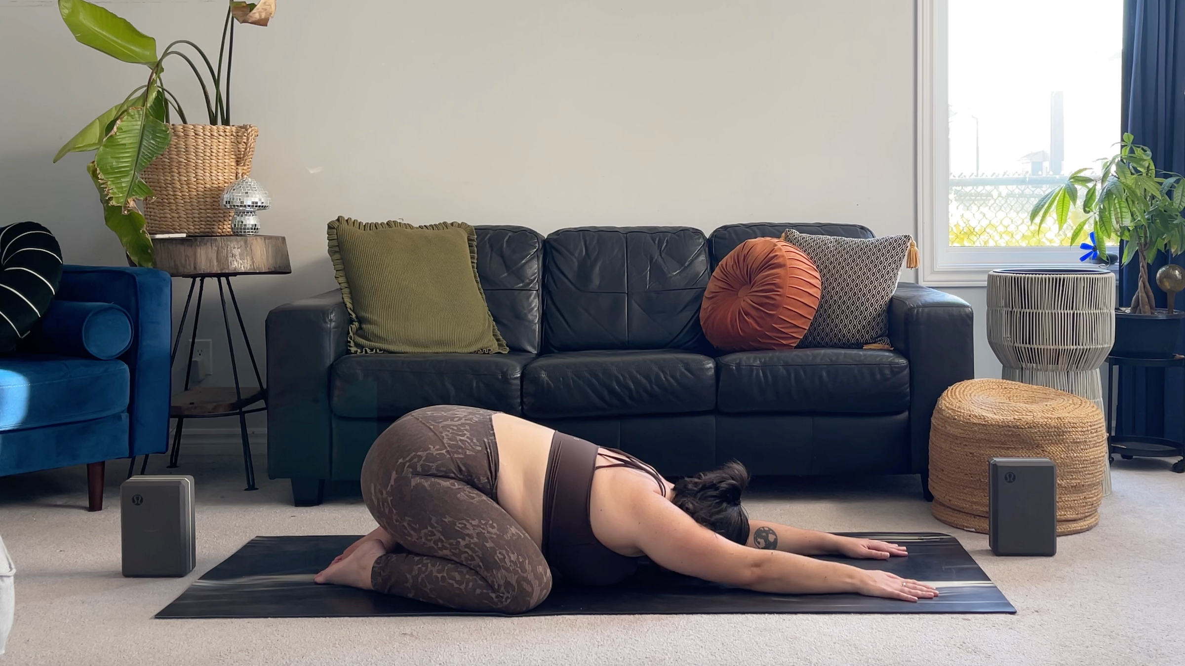 Yoga teacher Taylor Lorenz in Child's Pose, part of her full moon yoga routine