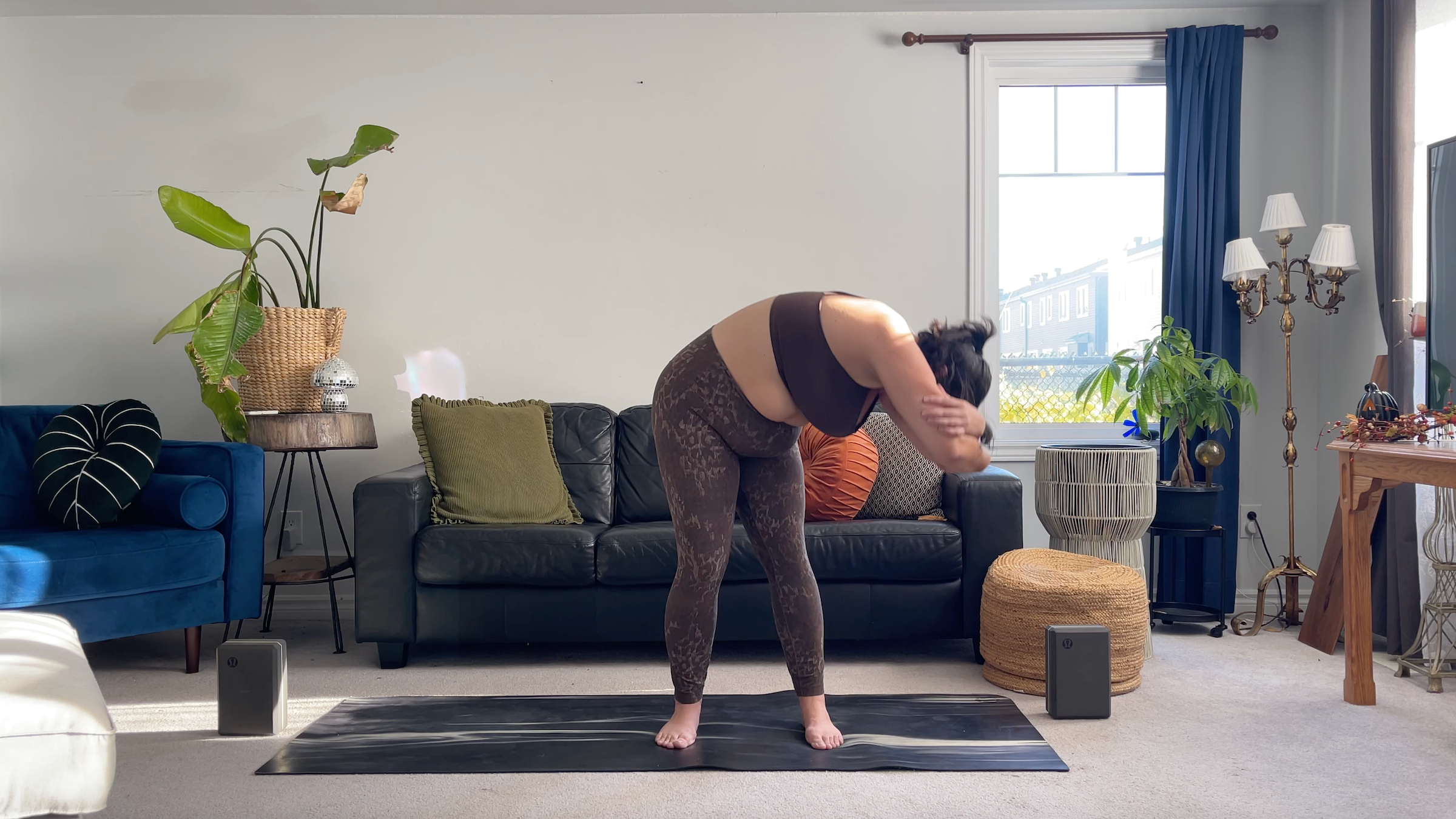 Yoga teacher Taylor Lorenz in Standing Forward Bend Circles, part of her full moon yoga routine