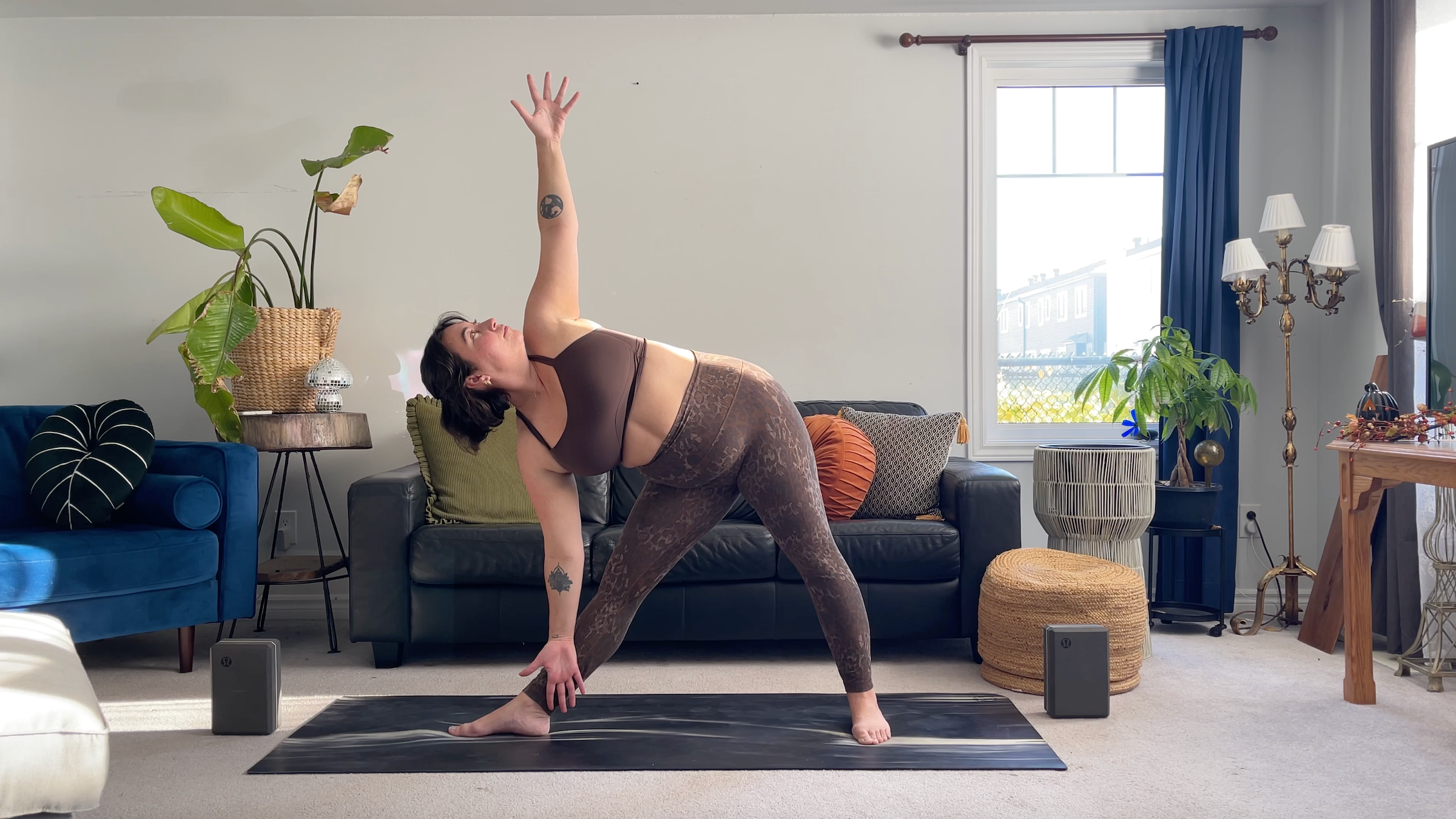 Yoga teacher Taylor Lorenz in in Triangle Pose, part of her full moon yoga flow