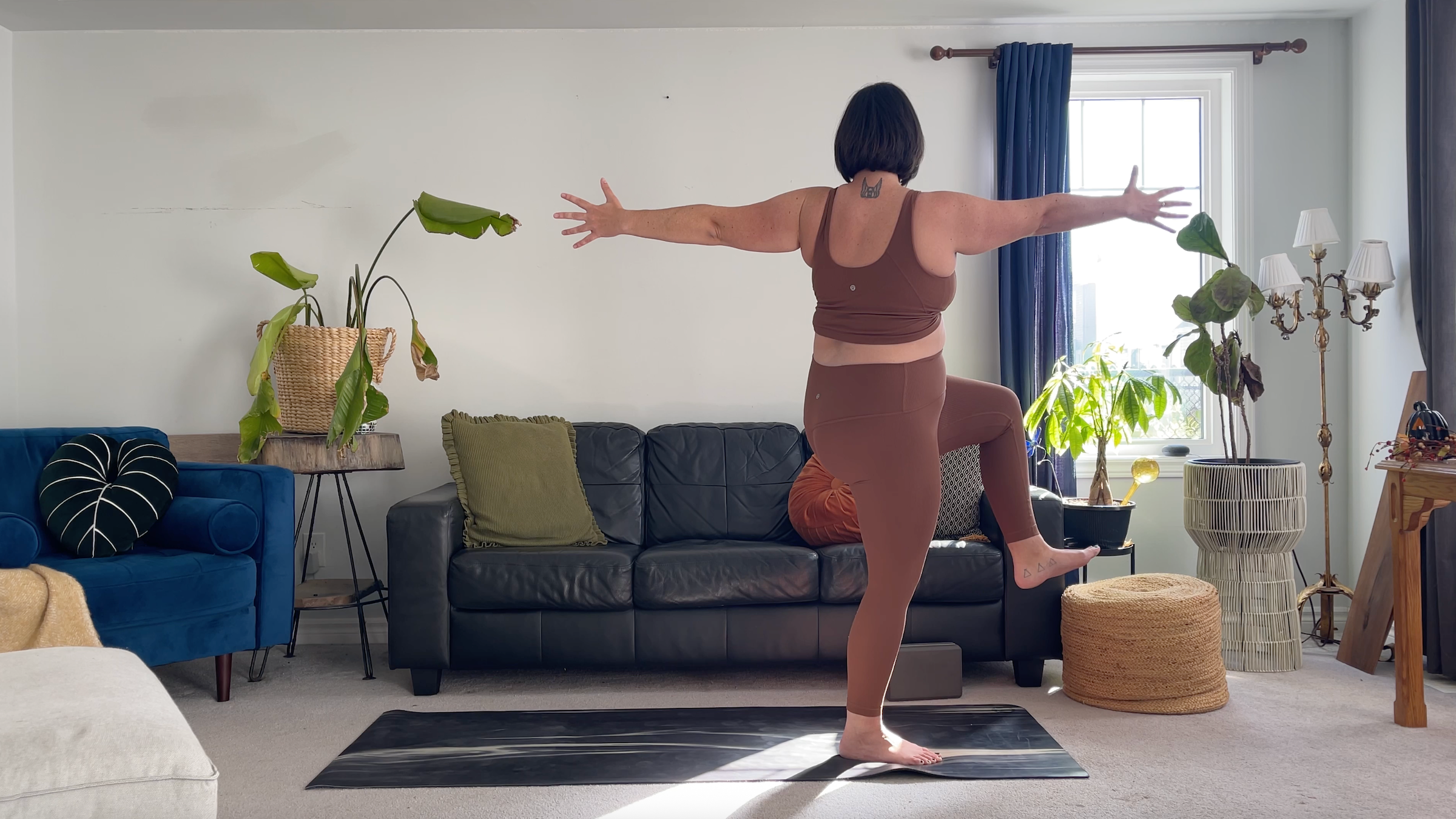 Yoga teacher Taylor Lorenz in Standing Twist, part of her morning yoga routine