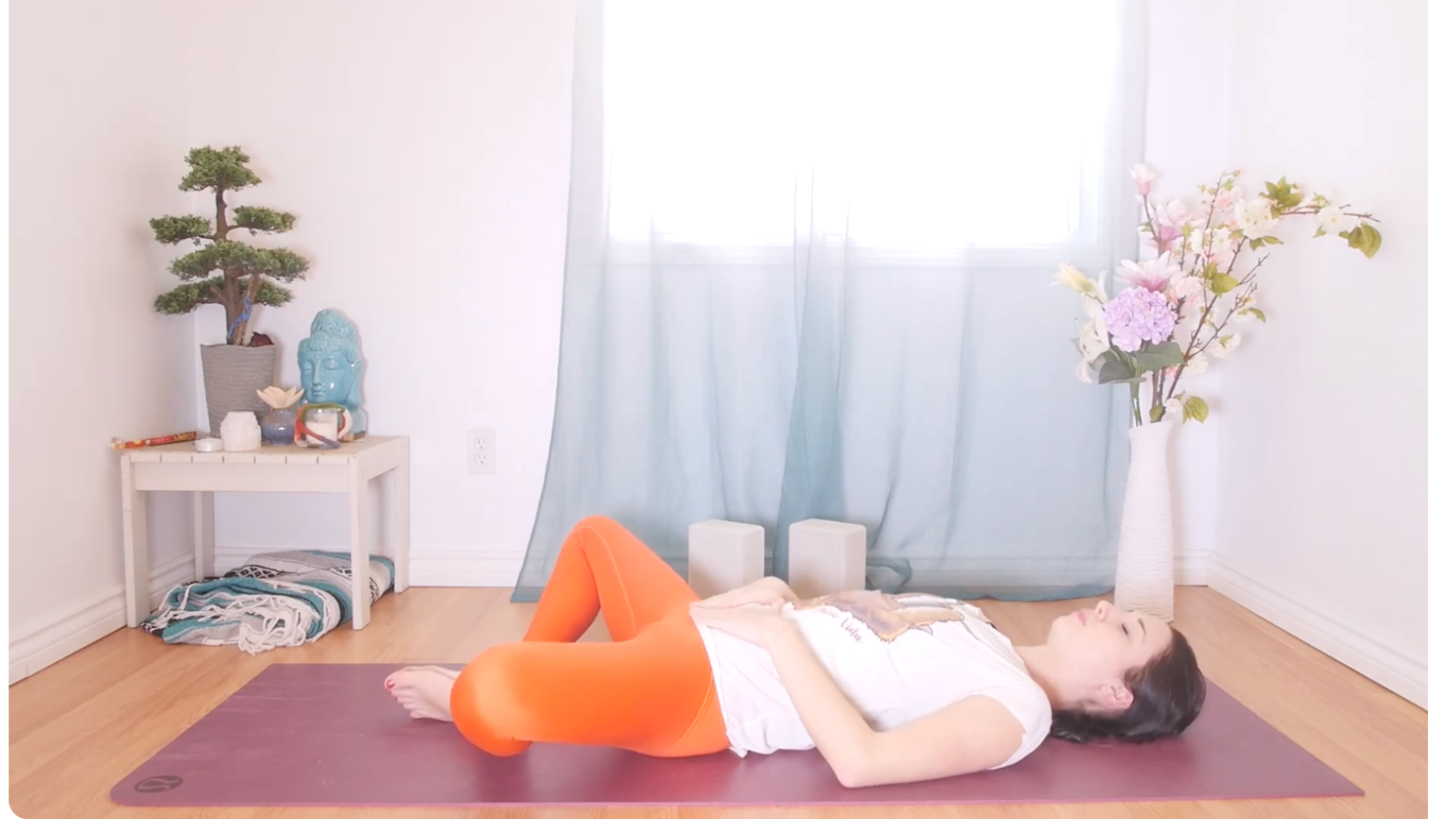 Woman lying on her back in a yin yoga for hips pose