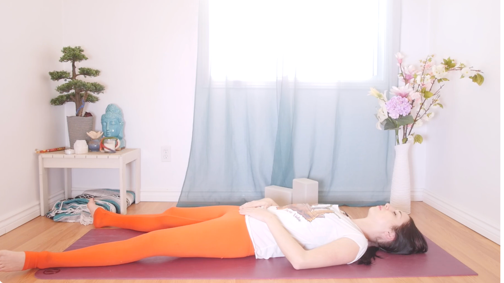 Woman lying on her back on a mat