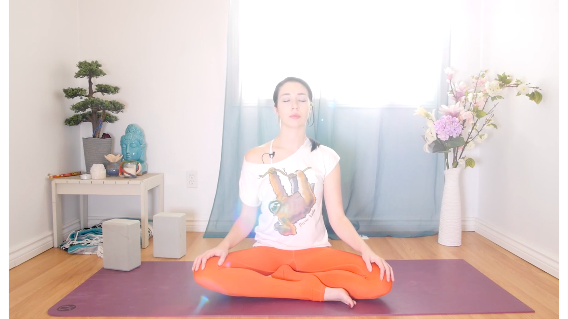 Woman sitting on a yoga mat cross-legged during yin yoga