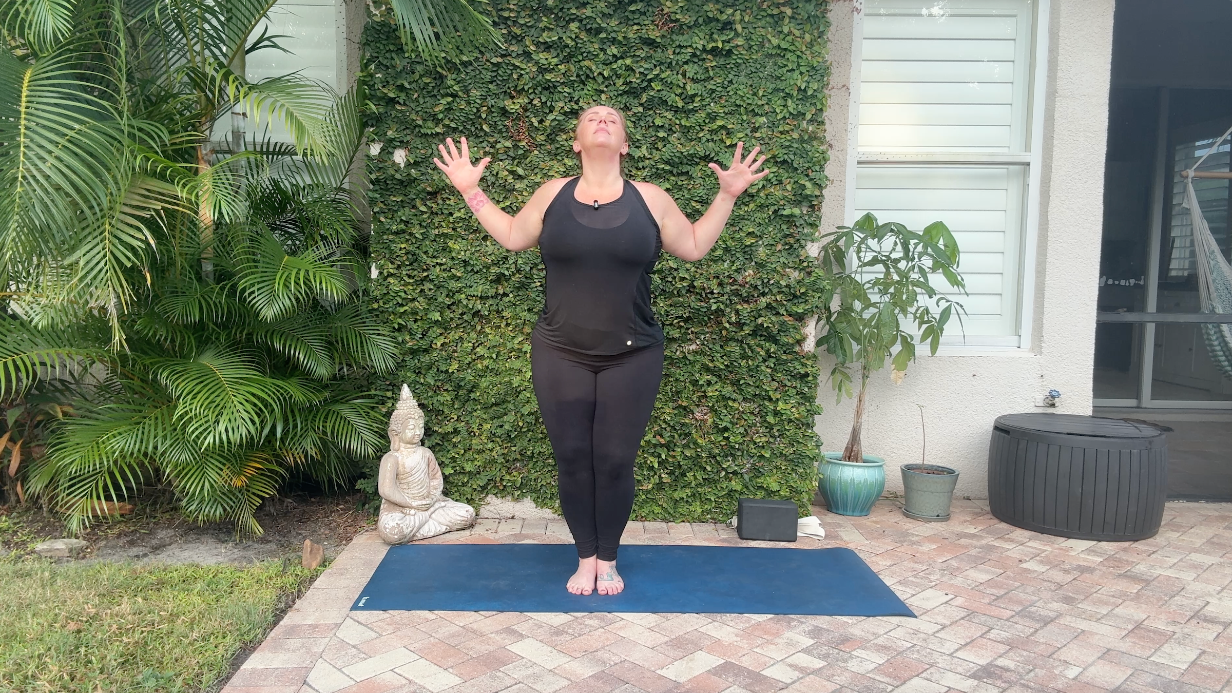 Yoga teacher Denver Clark practicing a chest opener, one of her arm strength exercises