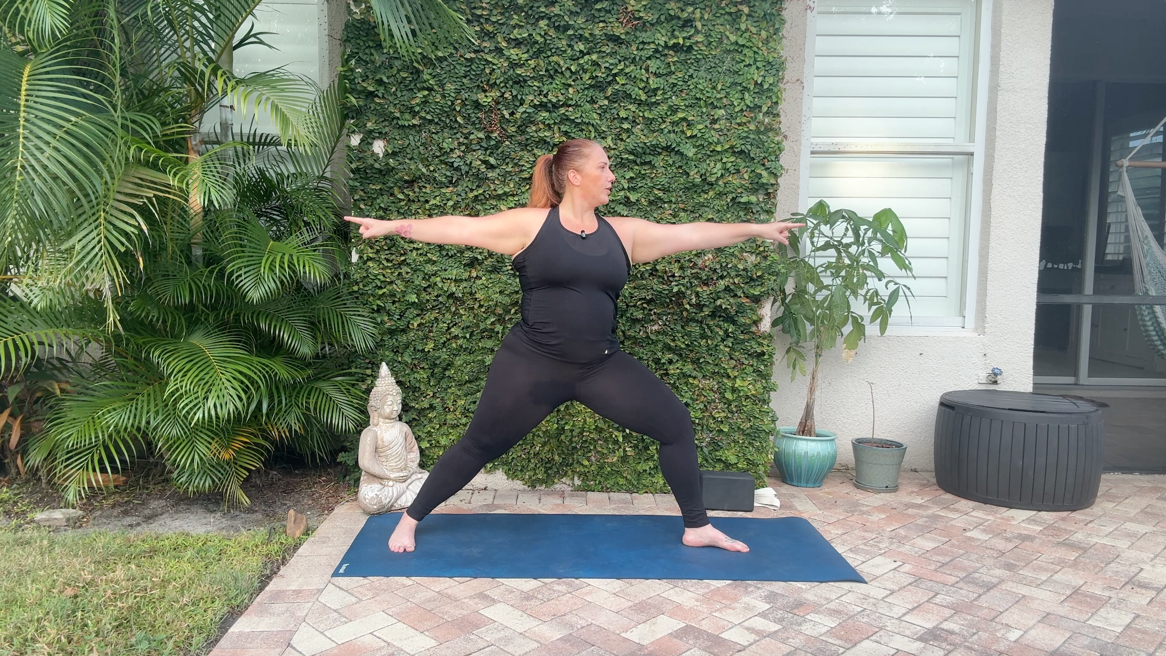 Denver Clark in Warrior II, part of her yoga for arm strength practice.