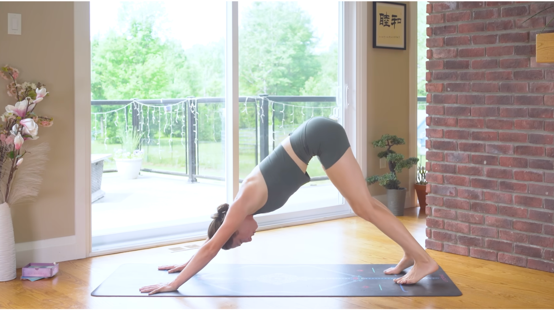 Woman in Downward-Facing Dog on a yoga mat 