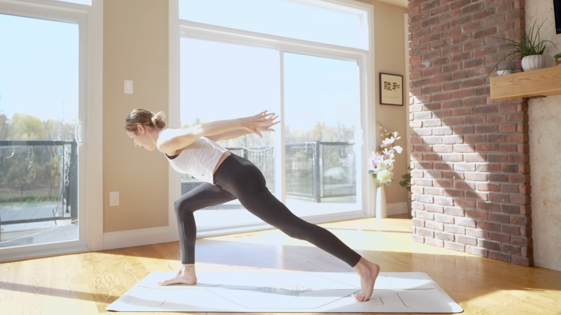 Woman on a yoga mat leaning forward from a High Lunge during 10-minute yoga