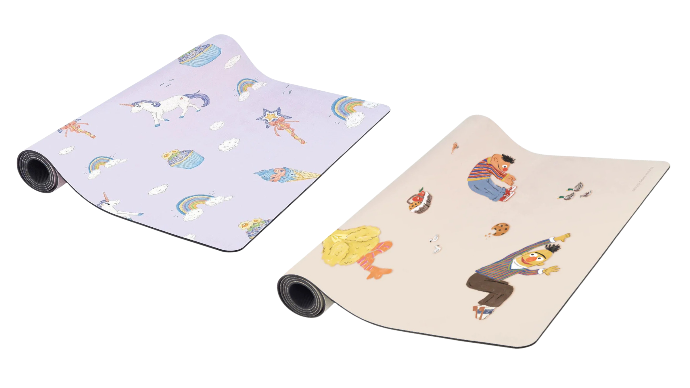 two halfway unrolled kids yoga mats with lavender unicorn pattern and Sesame Street pattern on white background