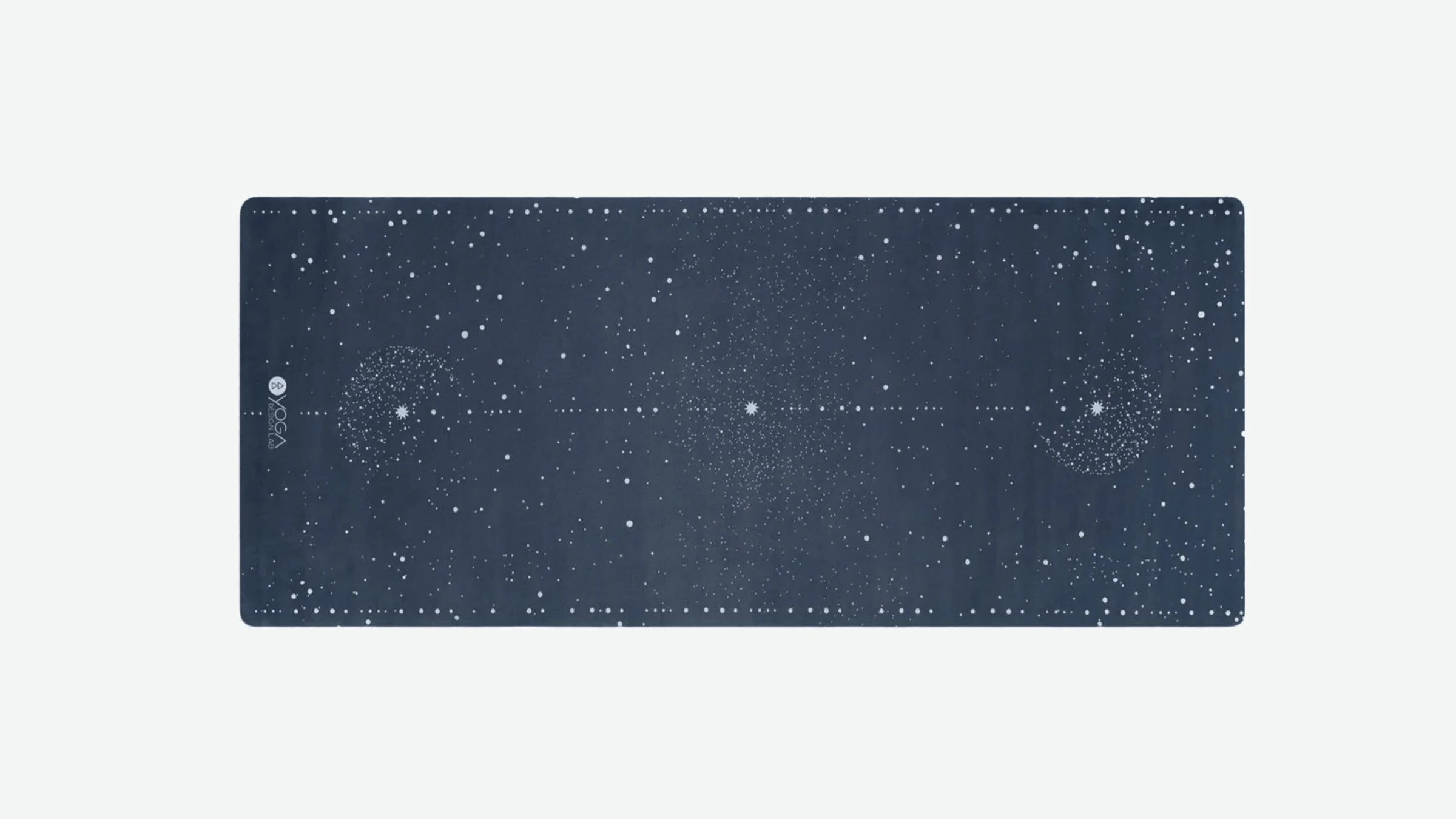 dark blue and star covered kids yoga mat unrolled on light gray background