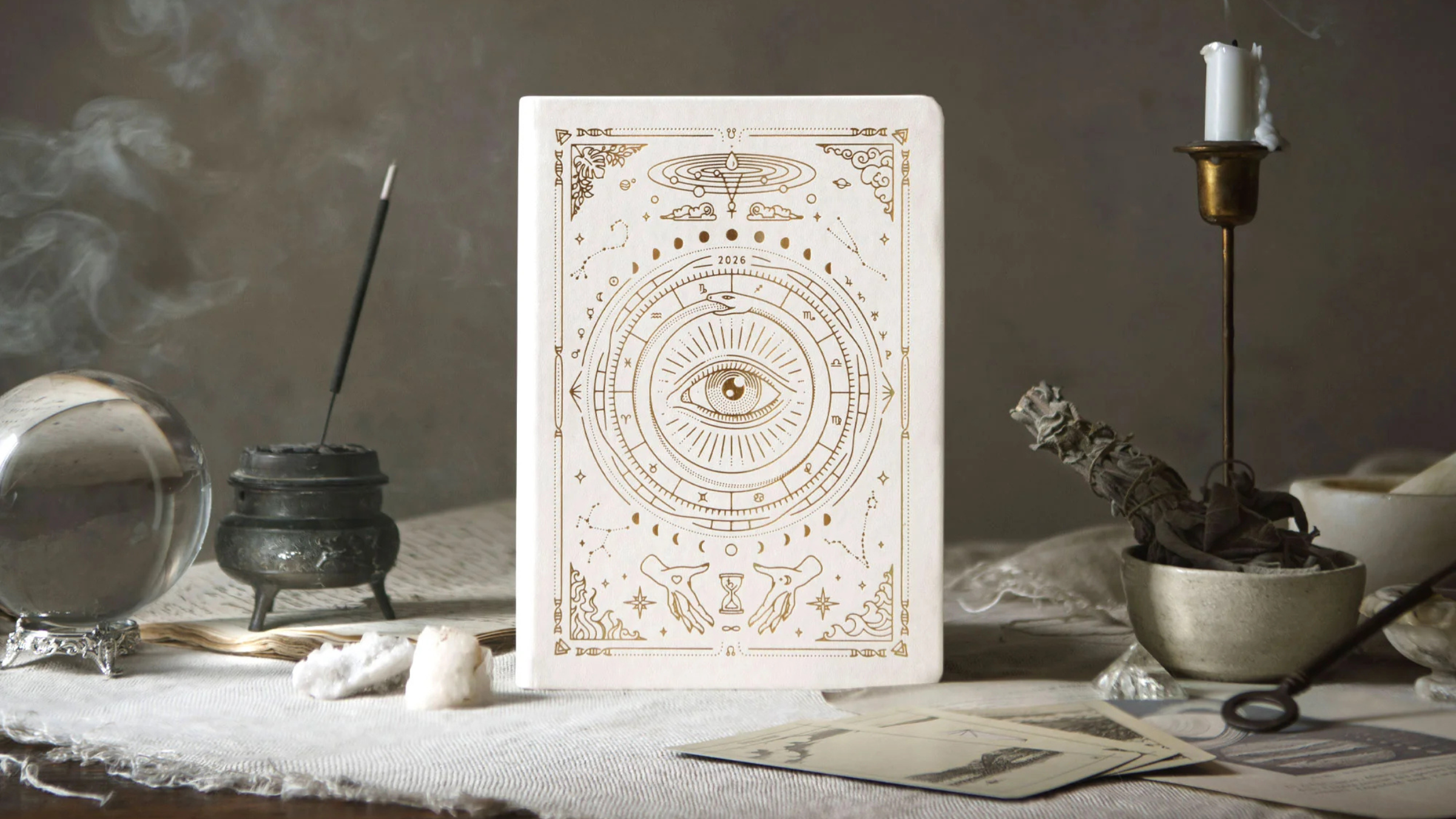 white journal on table top with incense burning in background, best yoga gifts