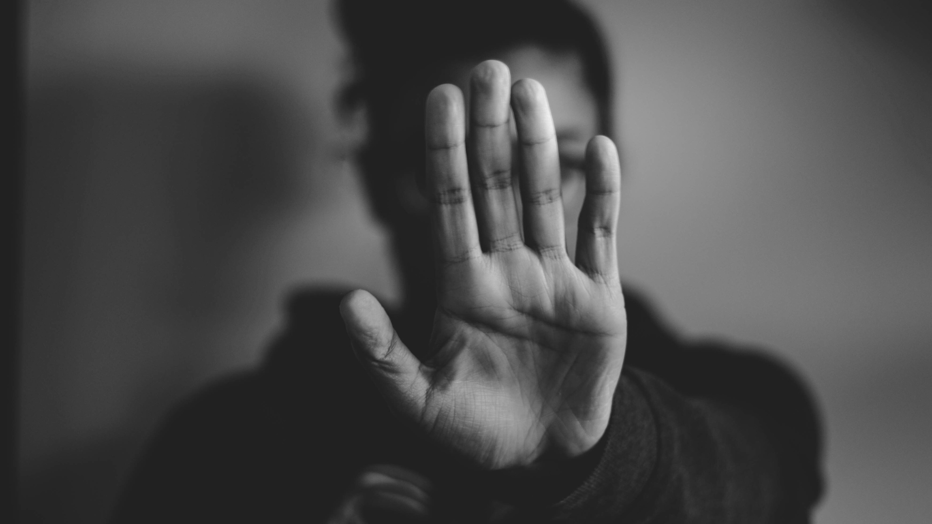 Woman holding her hand out in front of her face indicating saying "no" to bad yoga teaching advice