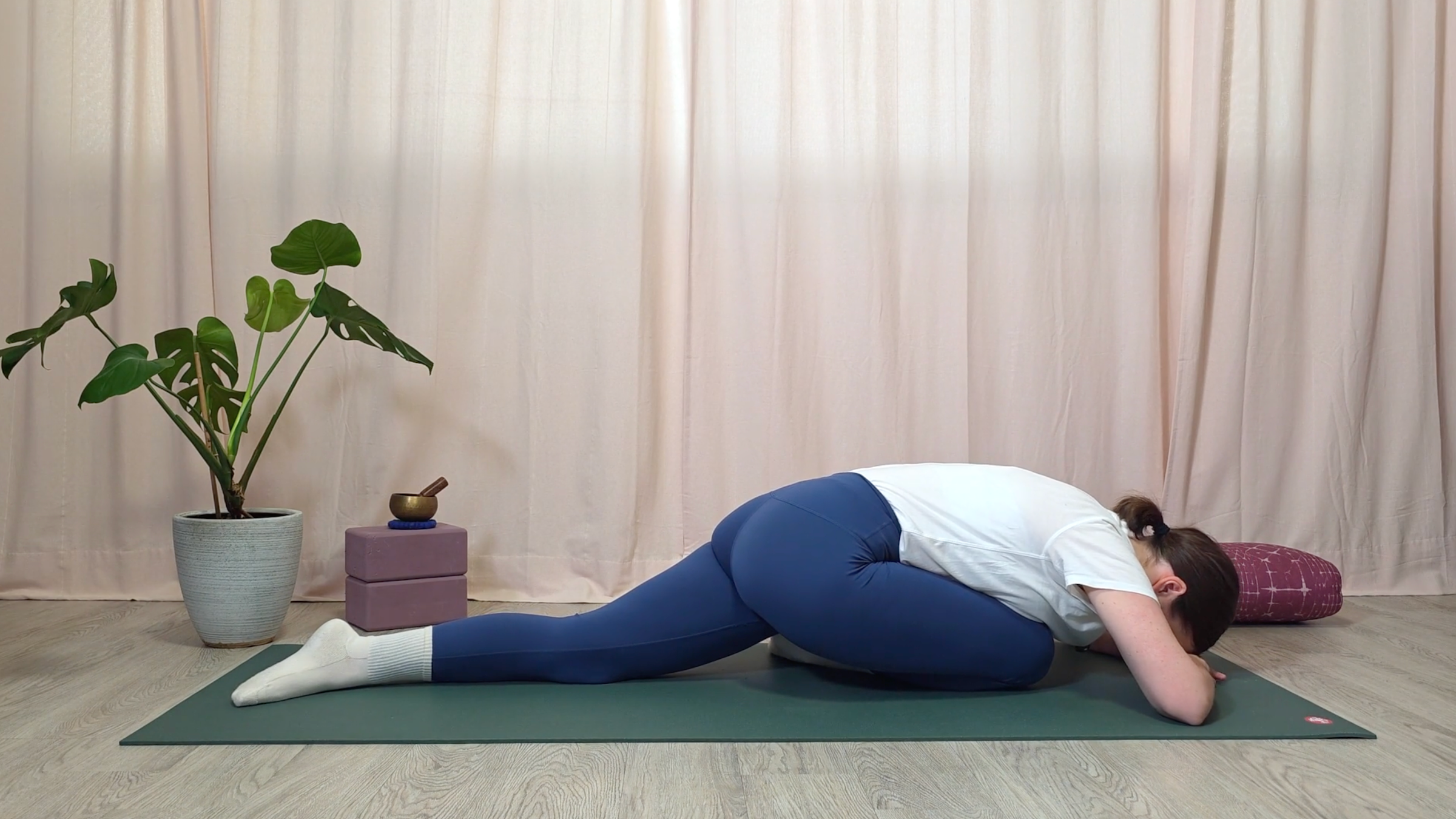 Teacher Katie McGrath in Dragon Pose