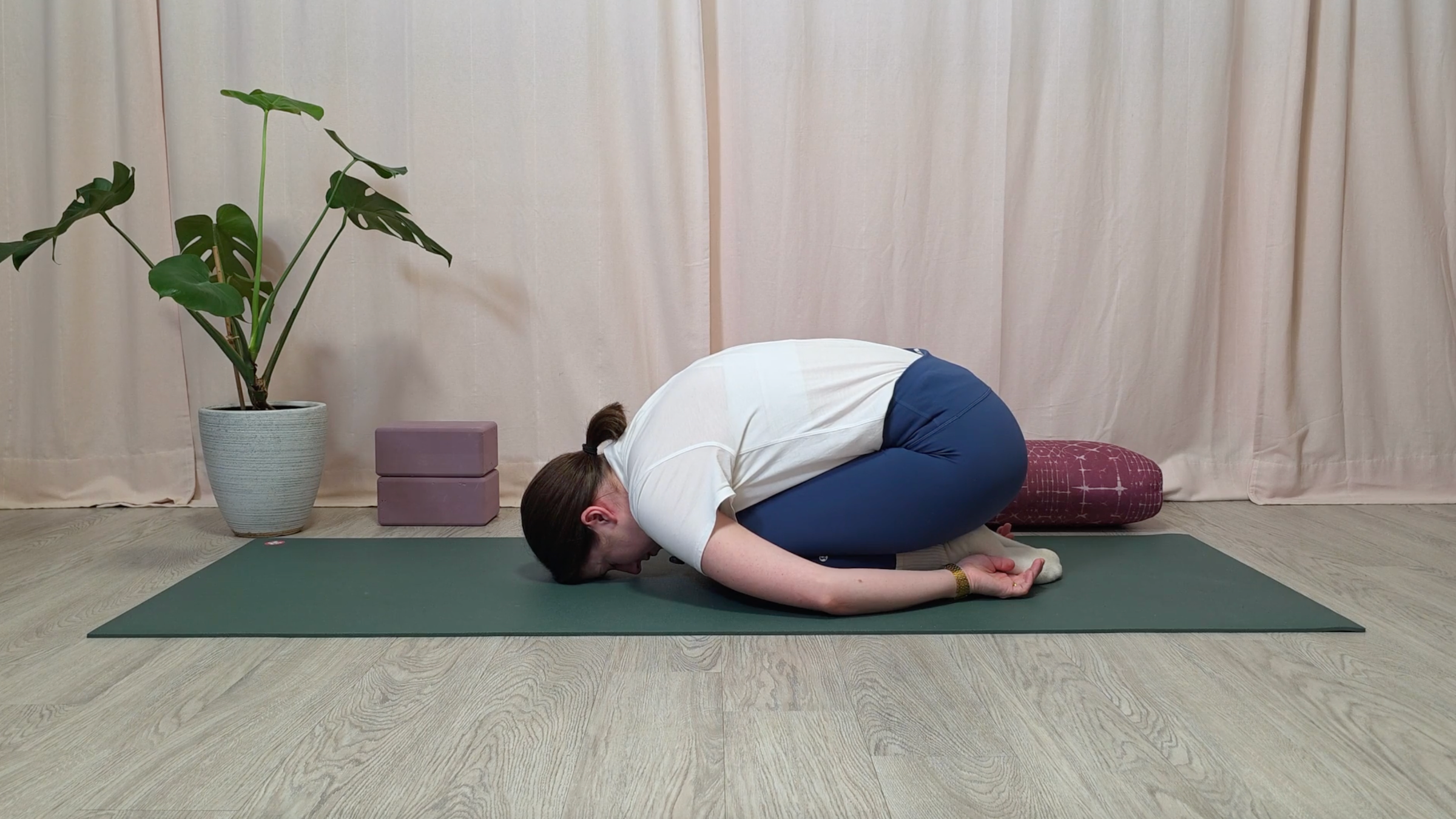 Yoga teacher Katie McGrath in Child's Pose, part of her yin yoga practice