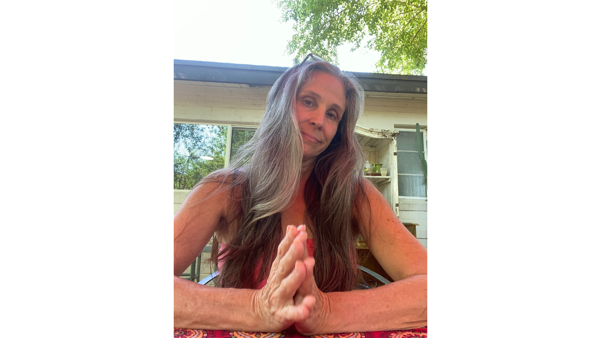Yoga teacher Nancy Ferraro sitting at a table