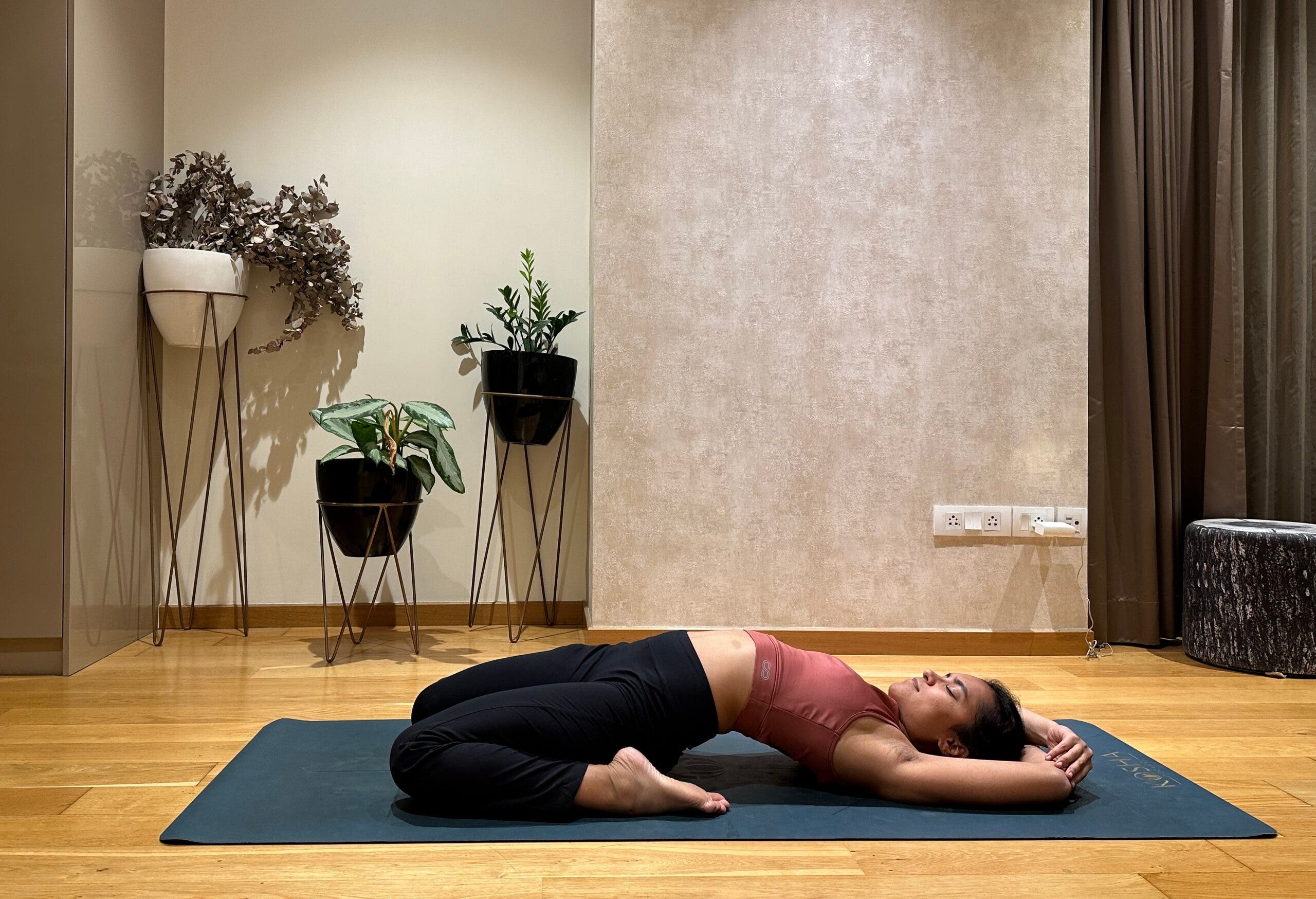 Riya Davda practicing Reclined Hero Pose