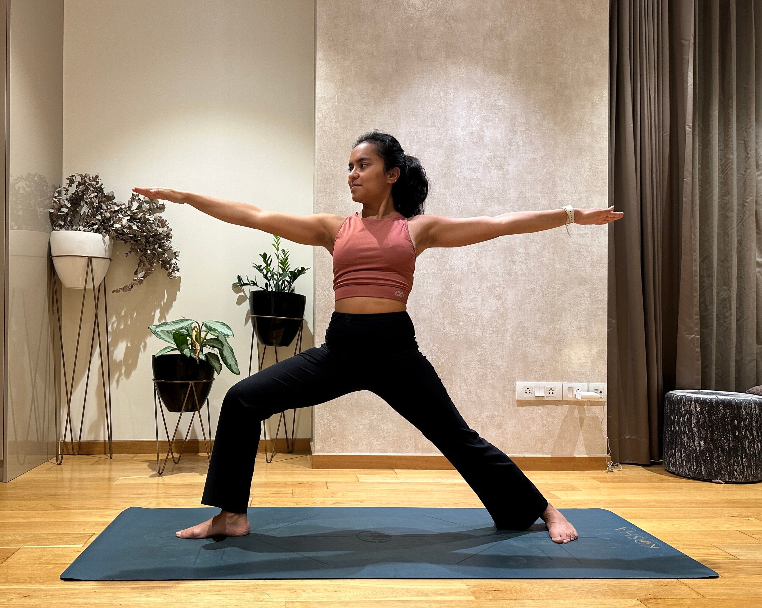 Riya Davda practicing Warrior 2