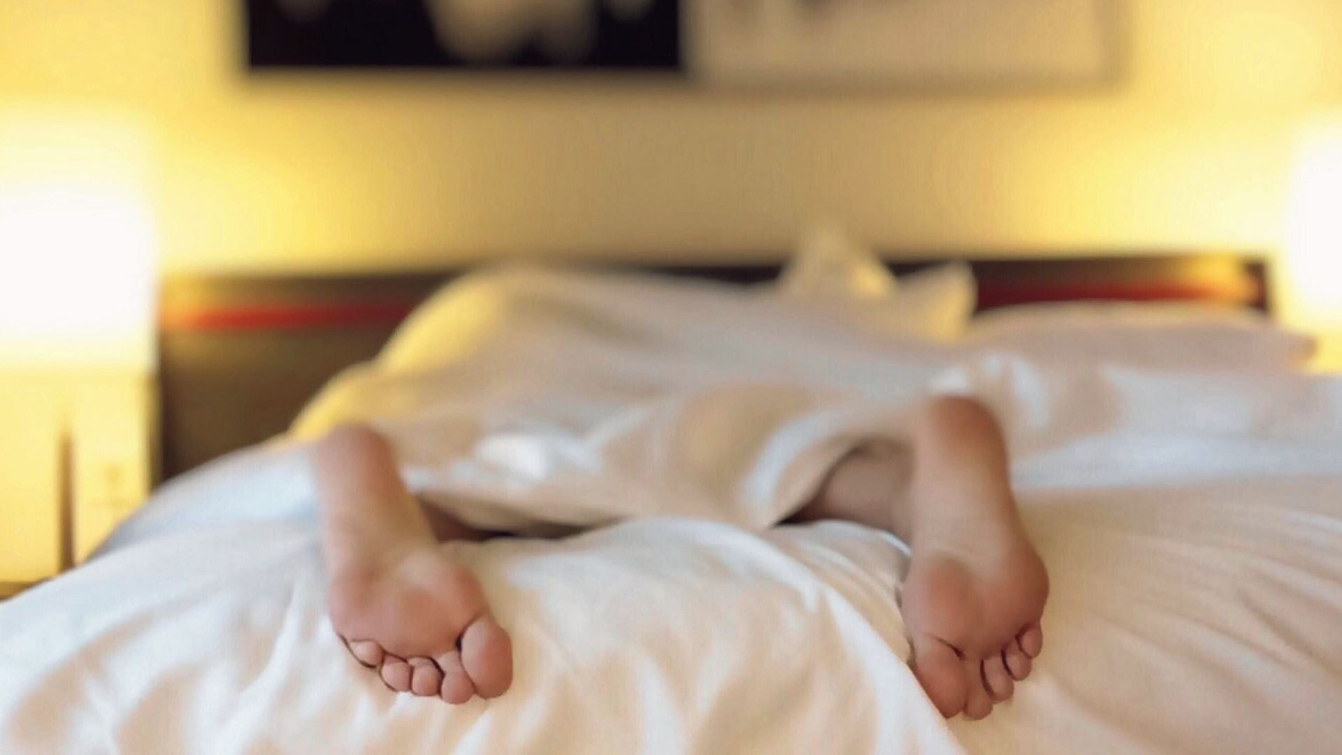 Image of person's feet in bed