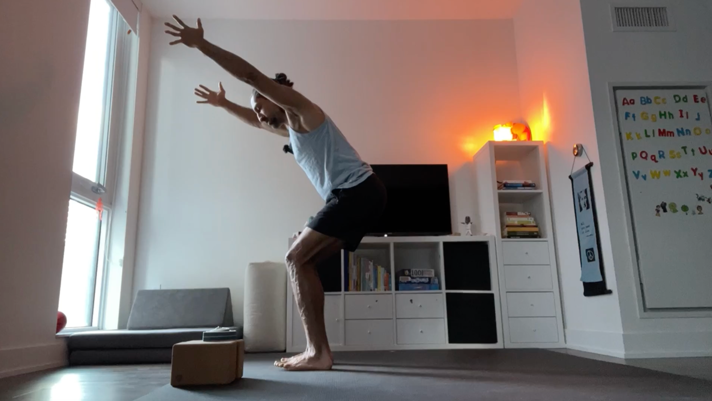 Yoga teacher Jaffer Hussain in Chair Pose, part of his simple yoga flow