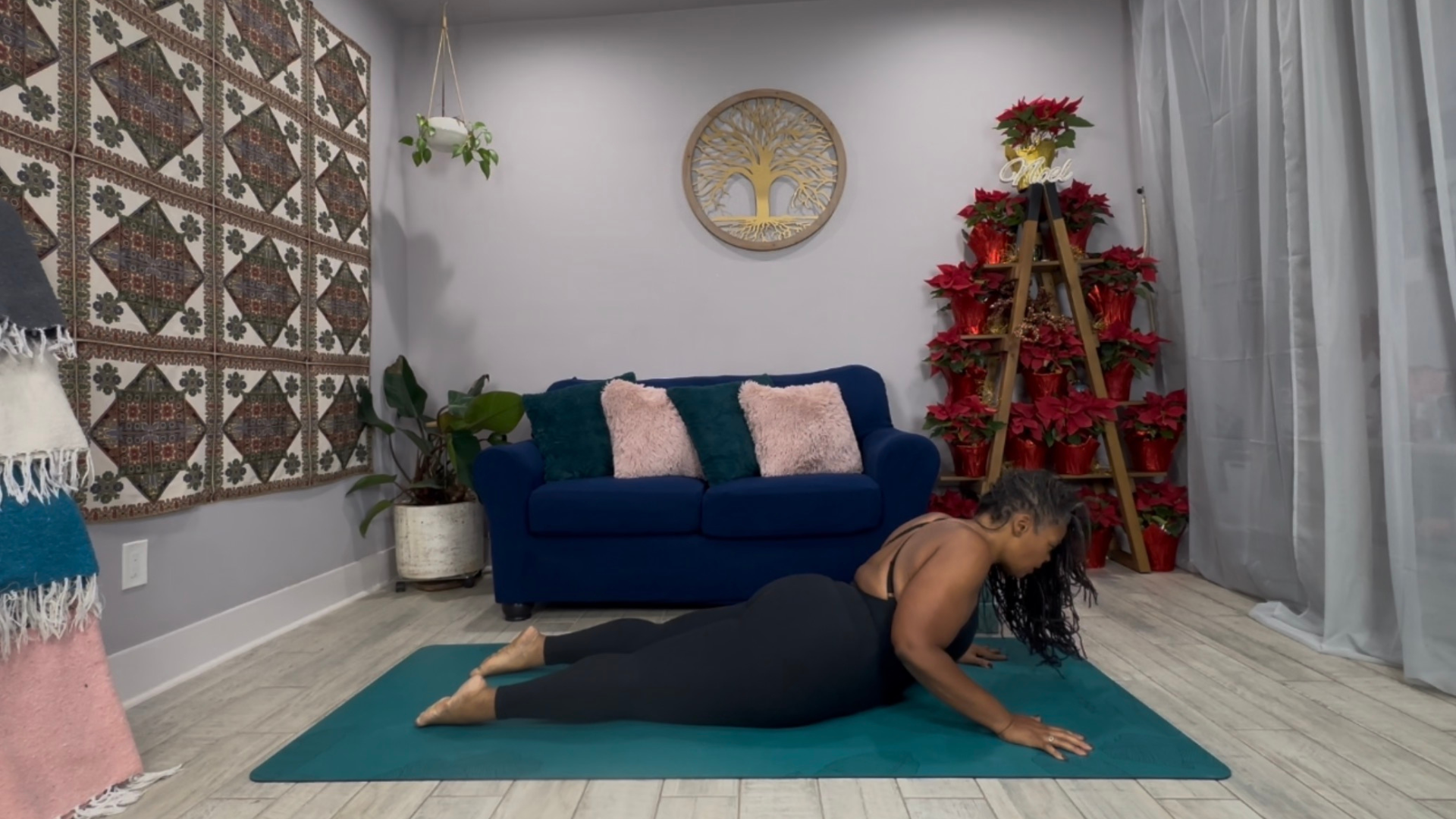 Woman lying on her belly on a yoga mat with her chest lifted