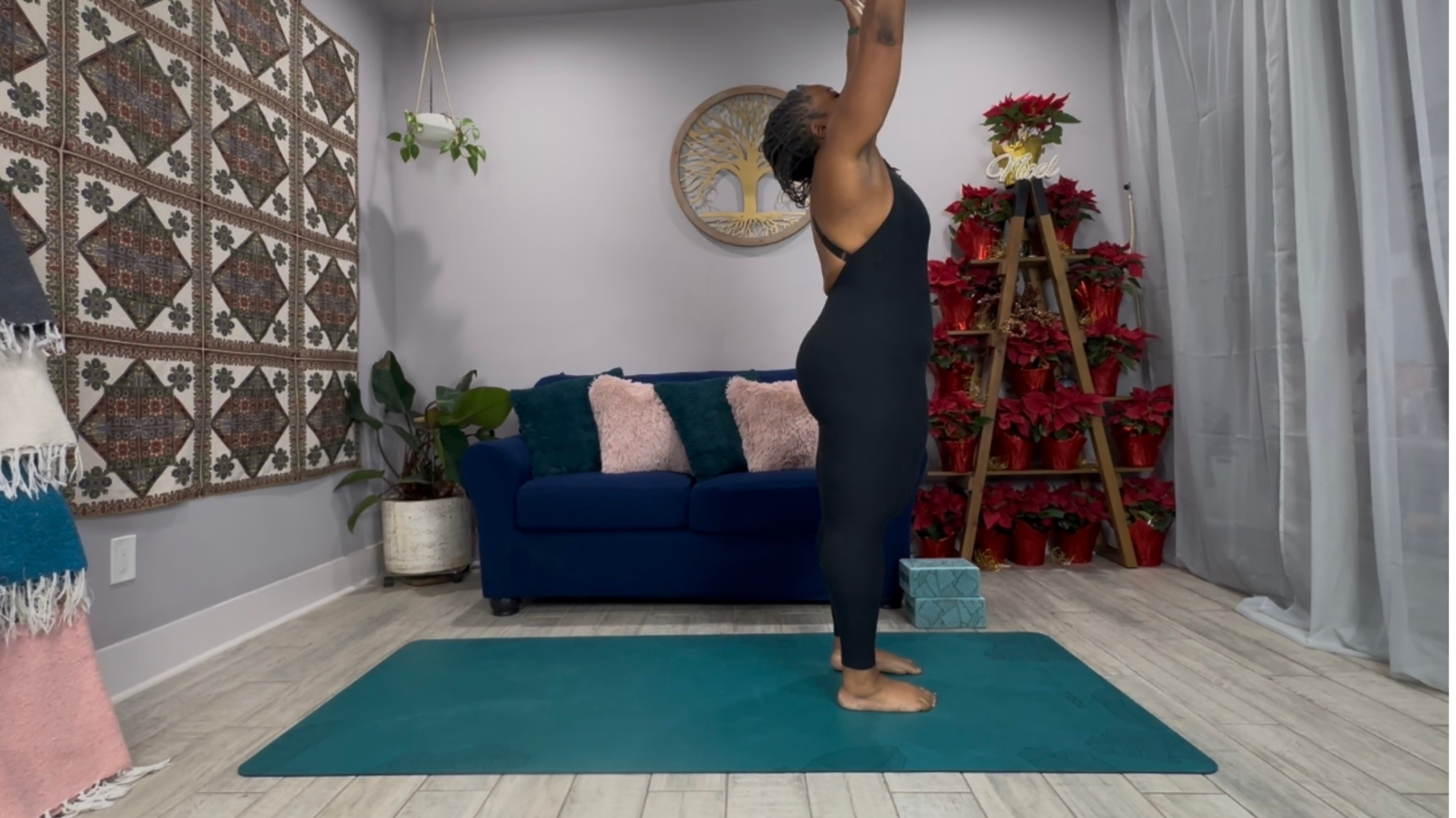 Woman practicing Urdhva Salute on a yoga mat