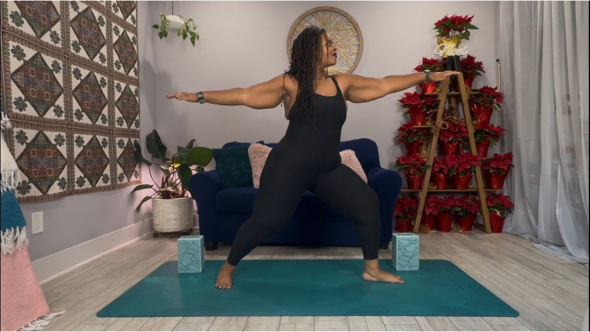 Woman on a yoga mat in Warrior 2