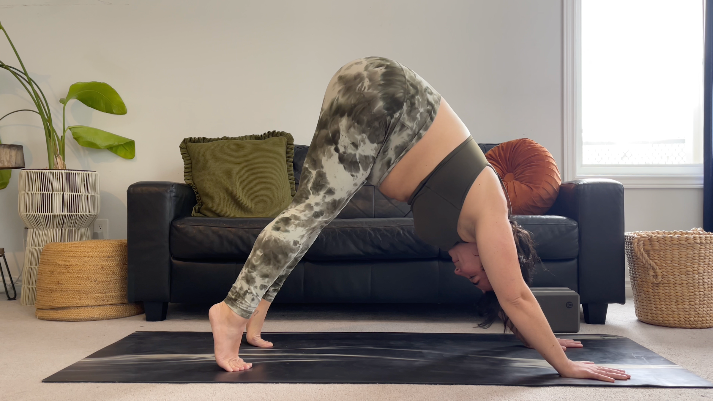 oga teacher Taylor Lorenz in Downward-Facing Dog, part of her yoga for feet practice