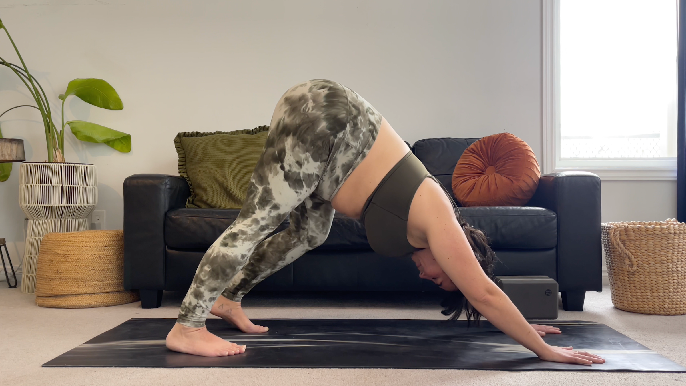 Yoga teacher Taylor Lorenz in Downward-Facing Dog, part of her yoga for feet practice