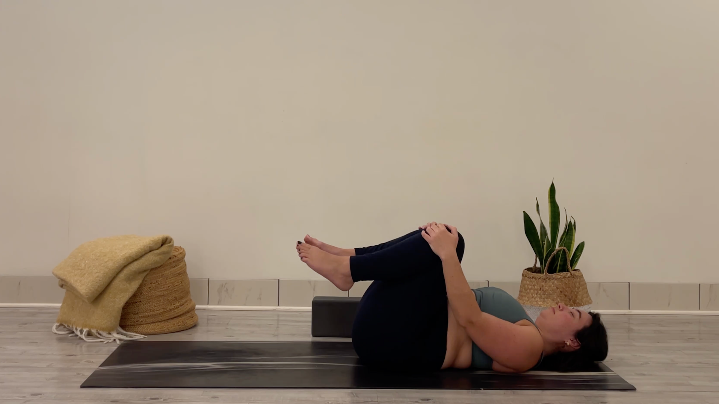 Teacher Taylor Lorenz in Knees to Chest, part of her yoga for focus practice