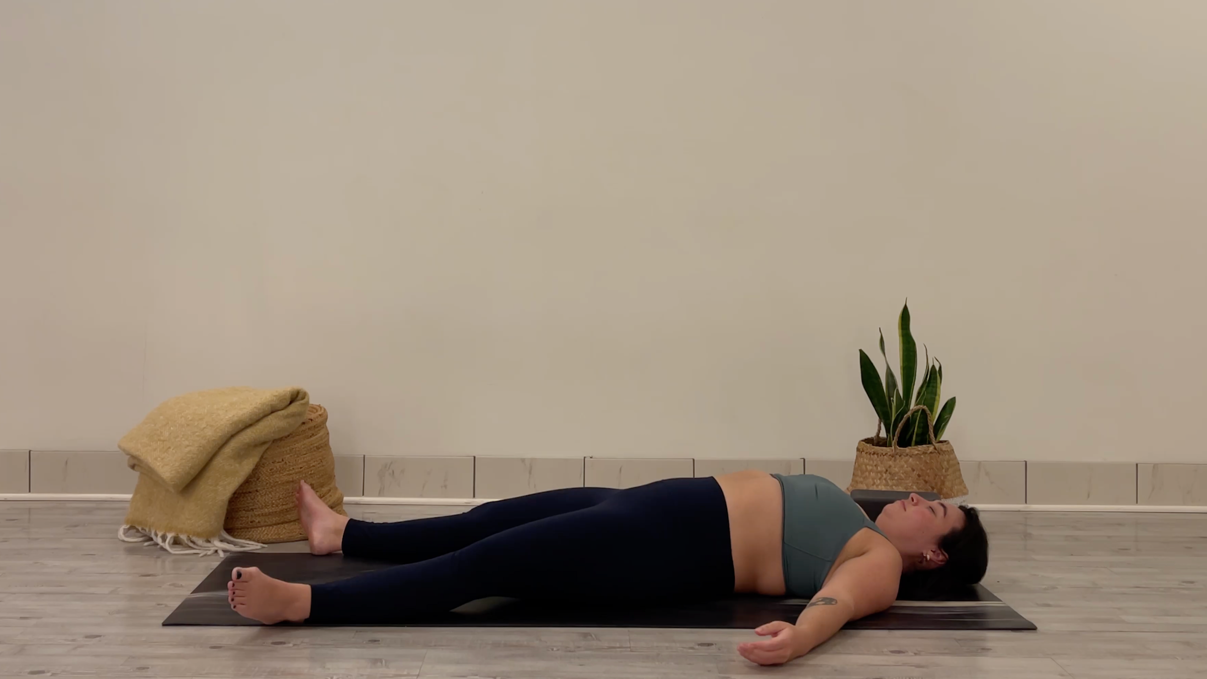 Teacher Taylor Lorenz in Savasana, part of her yoga for focus practice