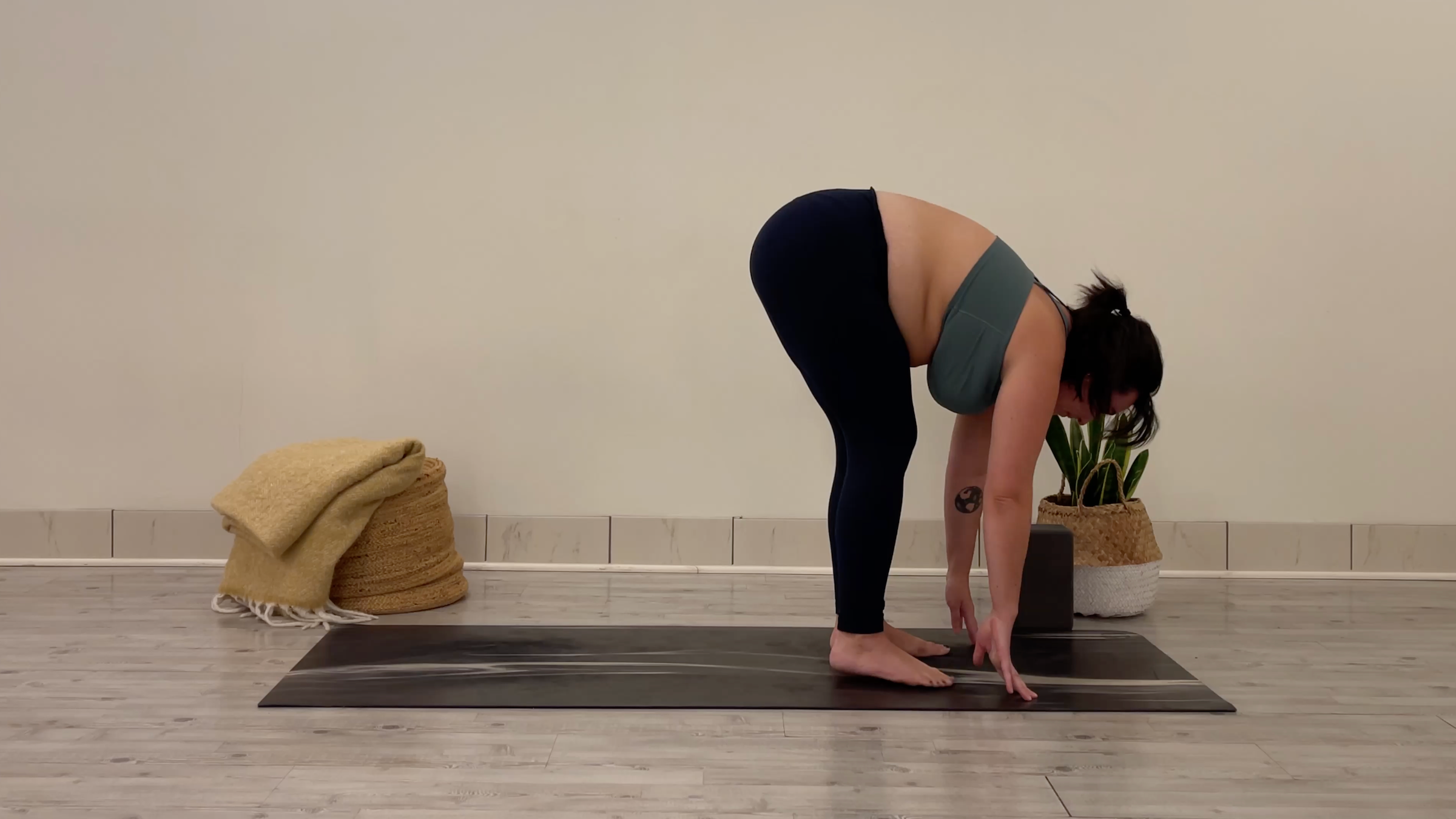Yoga teacher Taylor Lorenz in Standing Forward Bend, part of her yoga for focus practice