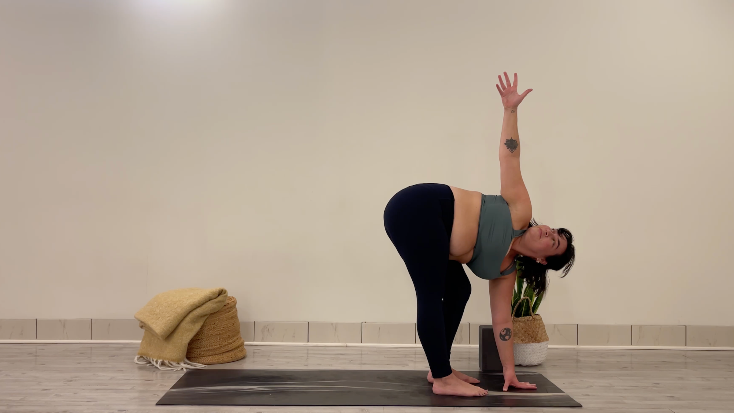Yoga teacher Taylor Lorenz in Twisting Standing Forward Bend, part of her yoga for focus practice