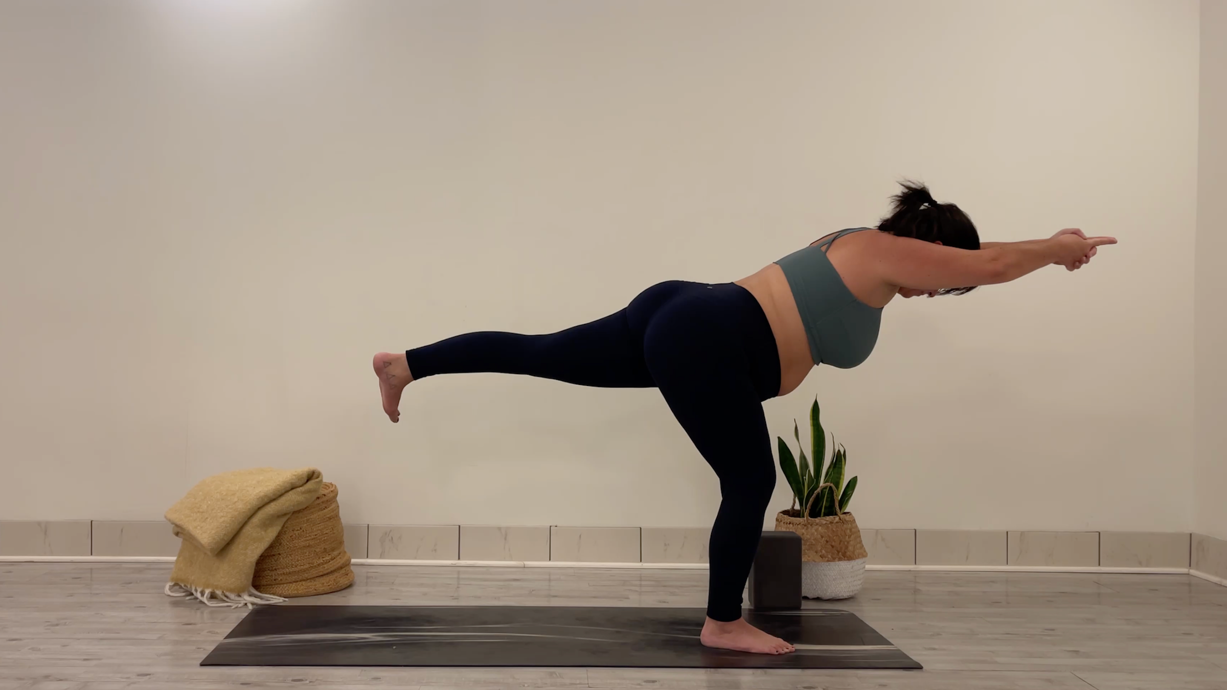 Yoga teacher Taylor Lorenz in Warrior 3, part of her yoga for focus practice