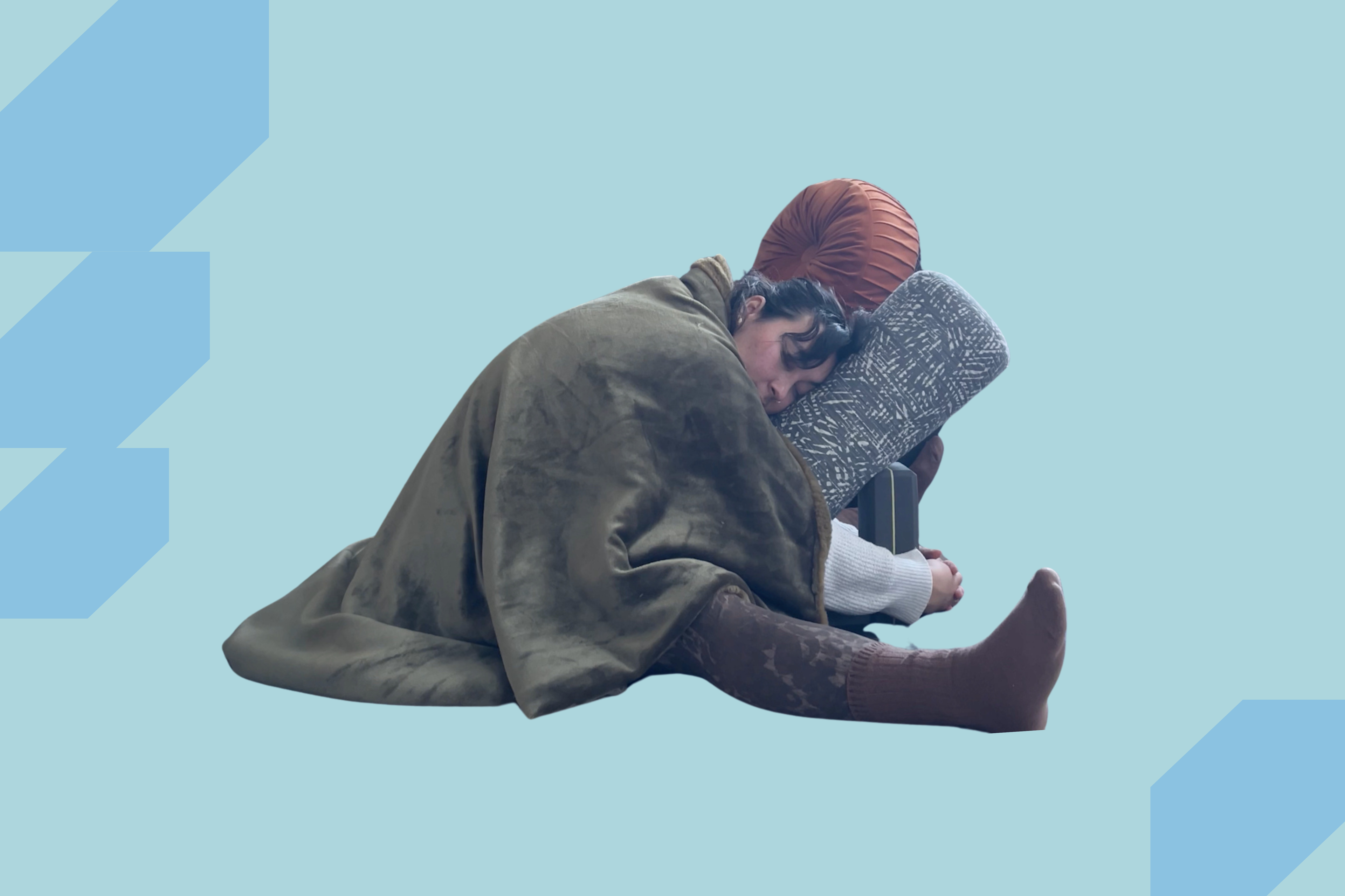 Taylor Lorenz in a Restorative Yoga pose with blankets