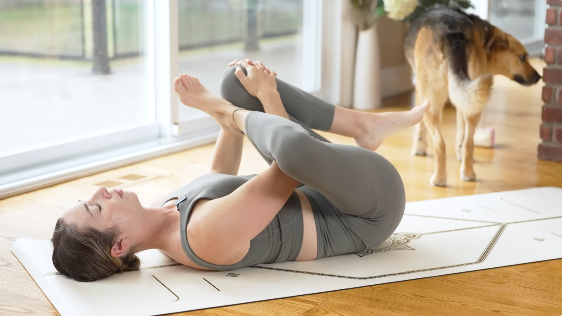Woman lying on her back with her right ankle crossed over against her left knee in a hip and glute stretch