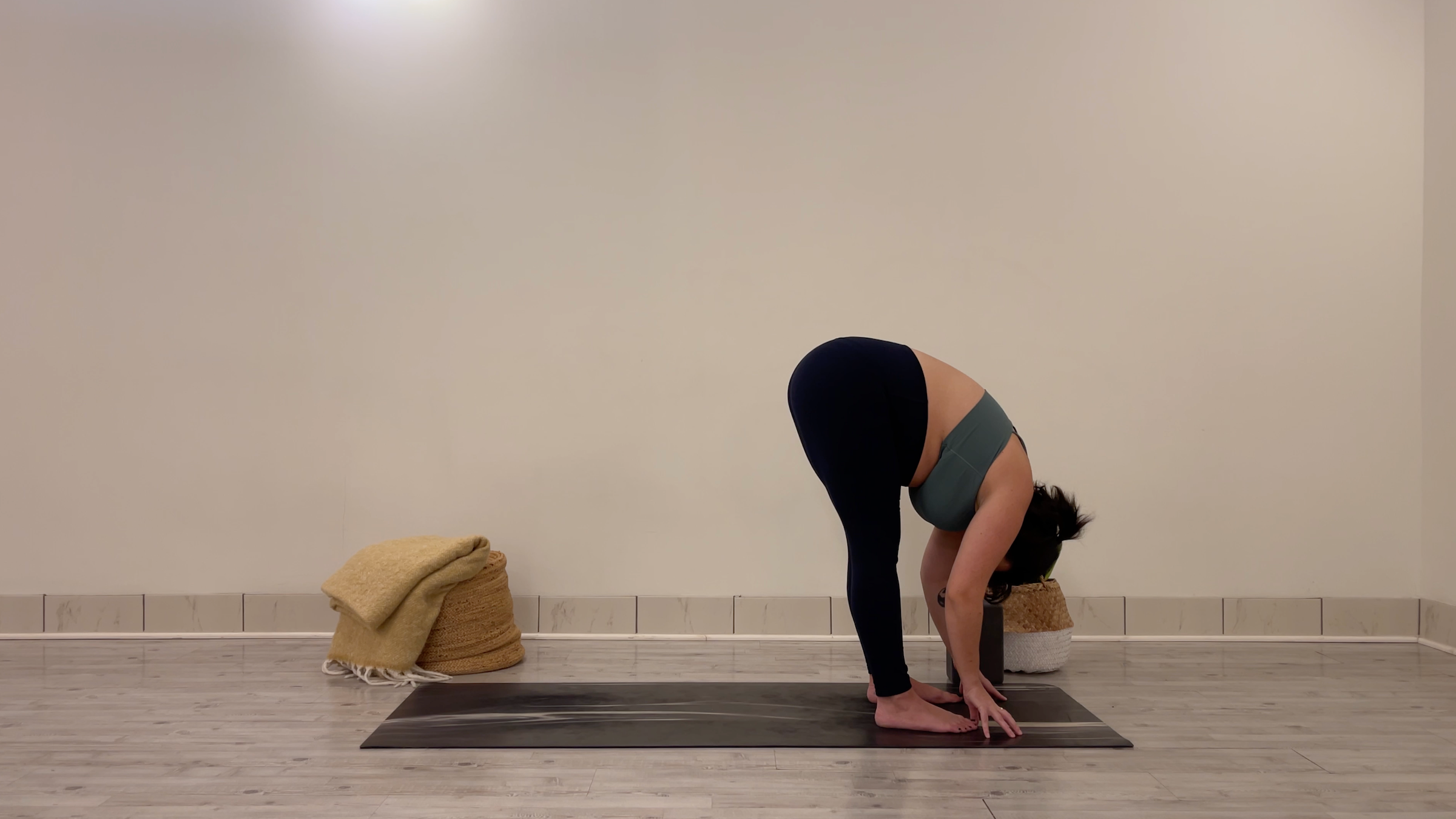 Teacher Taylor Lorenz in Standing Forward Bend