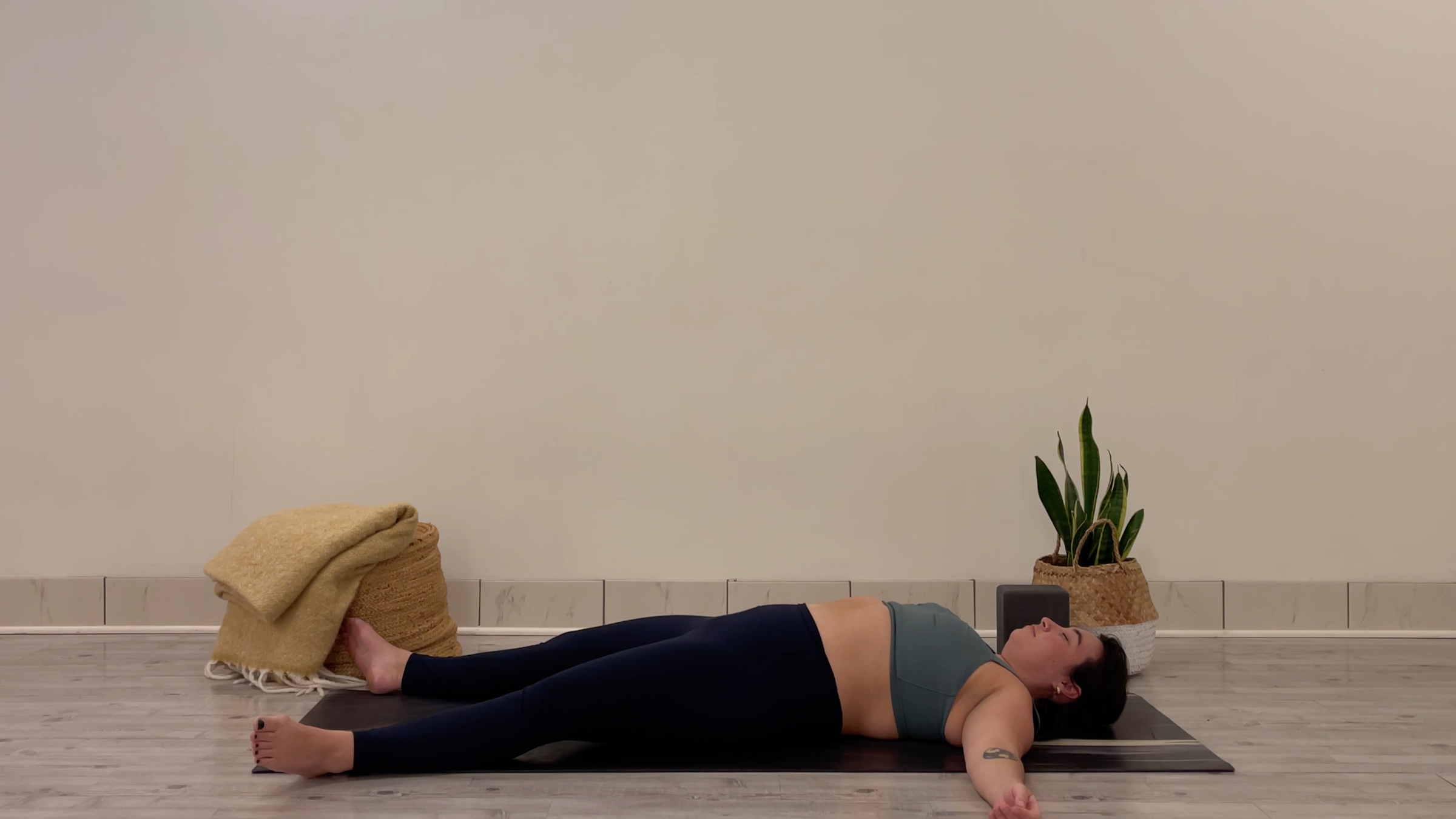 Yoga teacher Taylor Lorenz in Savasana, part of her morning yoga practice