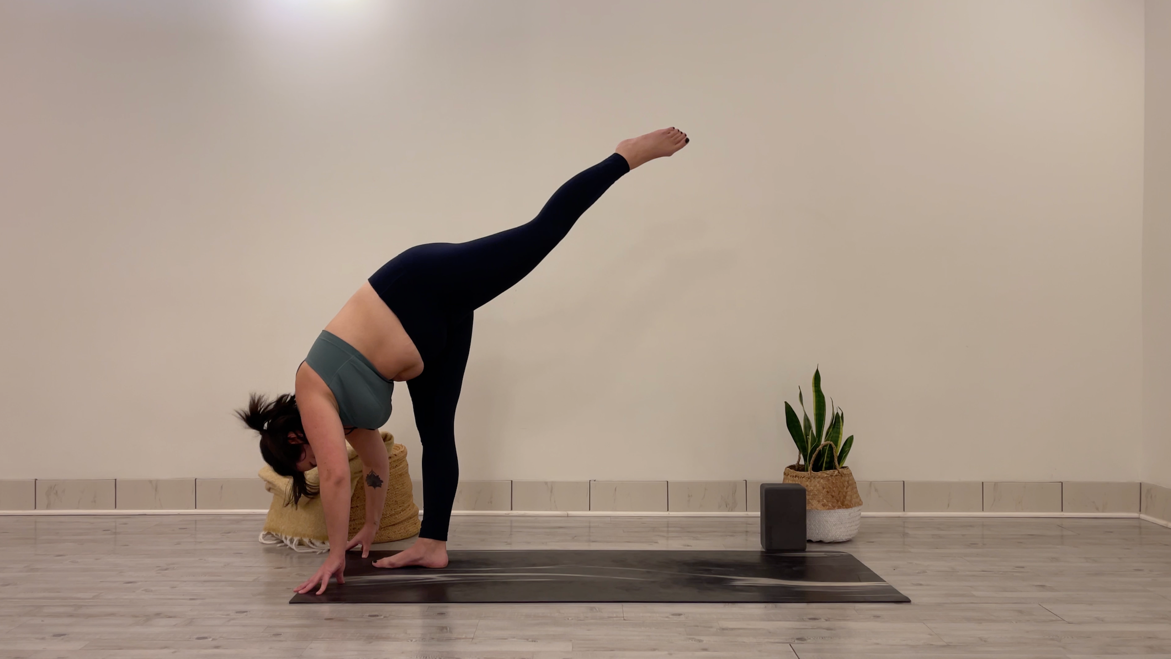 Yoga teacher Taylor Lorenz in Standing Splits, part of her morning yoga practice