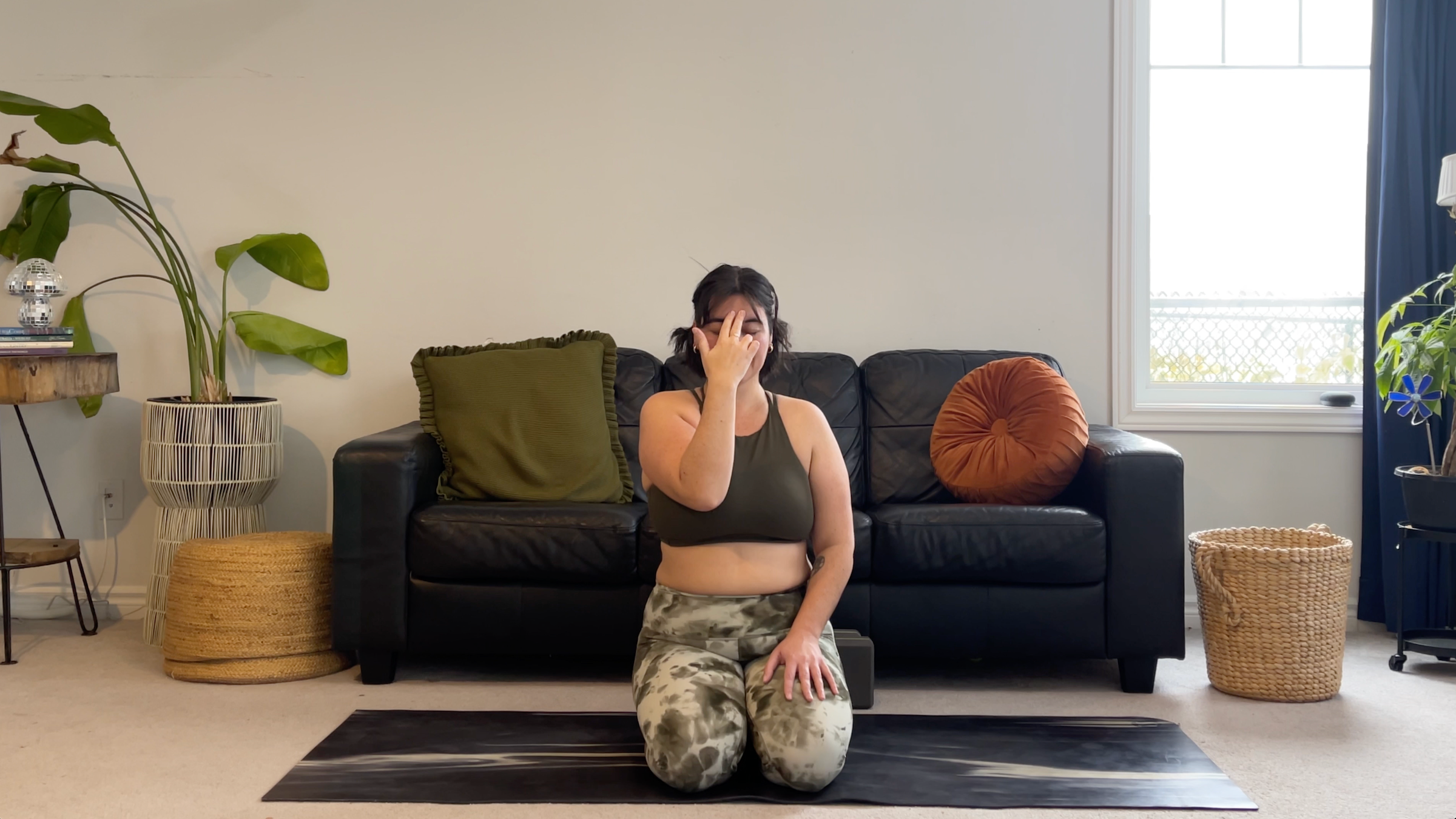 Yoga teacher Taylor Lorenz demonstrating Alternate Nostril Breathing, part of her new moon yoga practice