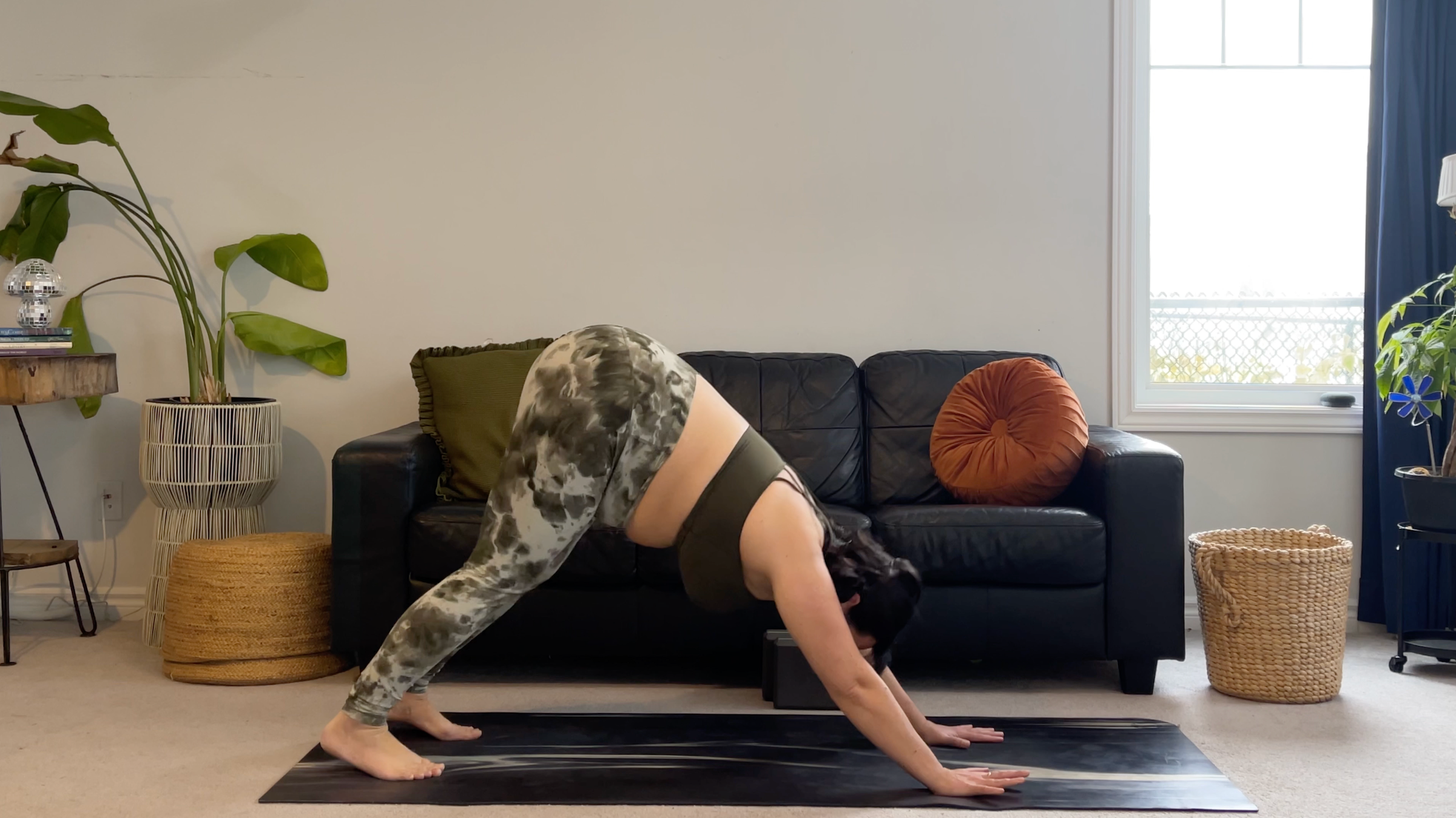 Yoga teacher Taylor Lorenz in Downward-Facing Dog, part of her new moon yoga practice