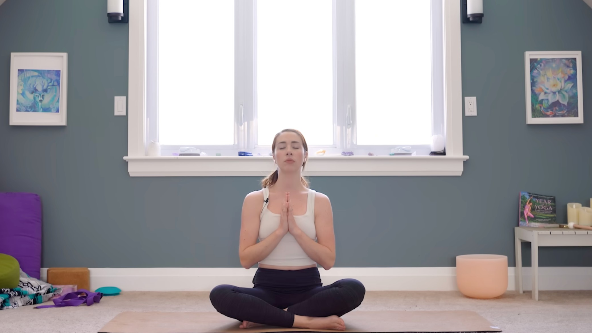 Woman sitting cross-legged with hands together