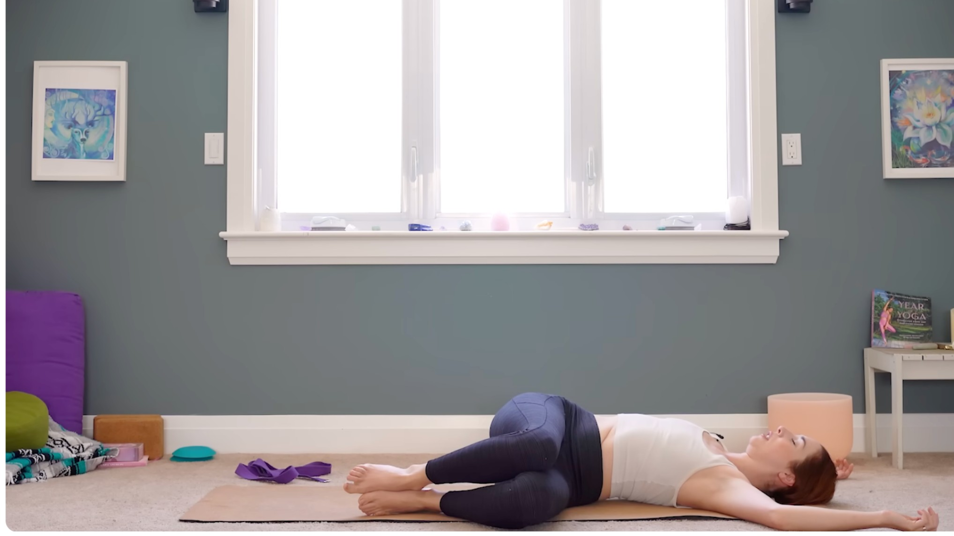 Woman reclining on a yoga mat in a twist