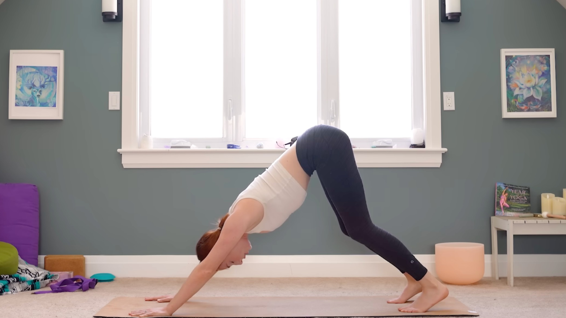 Woman in Downward-Facing Dog on a yoga mat