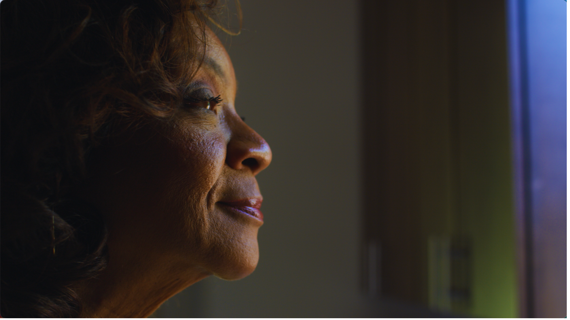 Elderly woman staring out a woman thinking about the stages of life